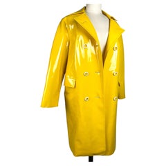 A yellow waterproof coat made of shiny PVC - France, circa 1965