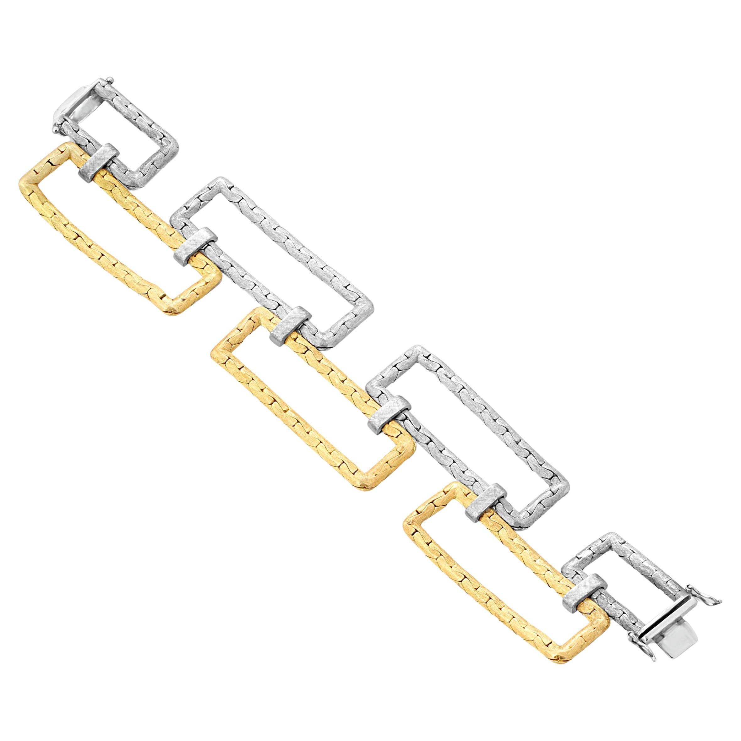 An elongated rectangular bracelet by Villa crafted from open links of textured white and yellow gold. Weight = 72.78gr. Circa 1970s.