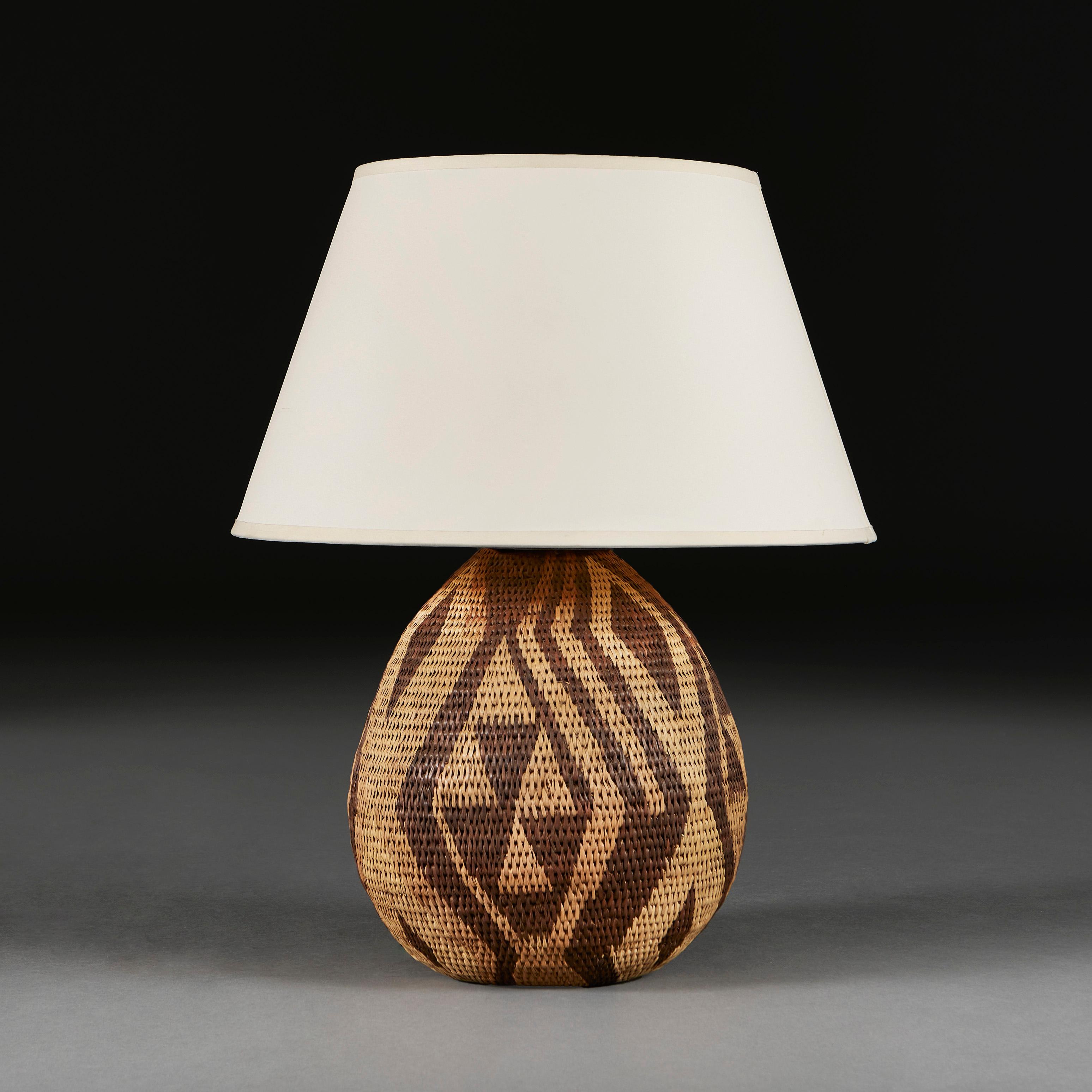 South Africa, 20th century

A mid twentieth century Zulu basketweave lamp, with geometric decoration throughout.

Please note:
Does not include the lampshade. Lamp has been photographed with a 16” pale cream Pembroke card lampshade.

Currently wired