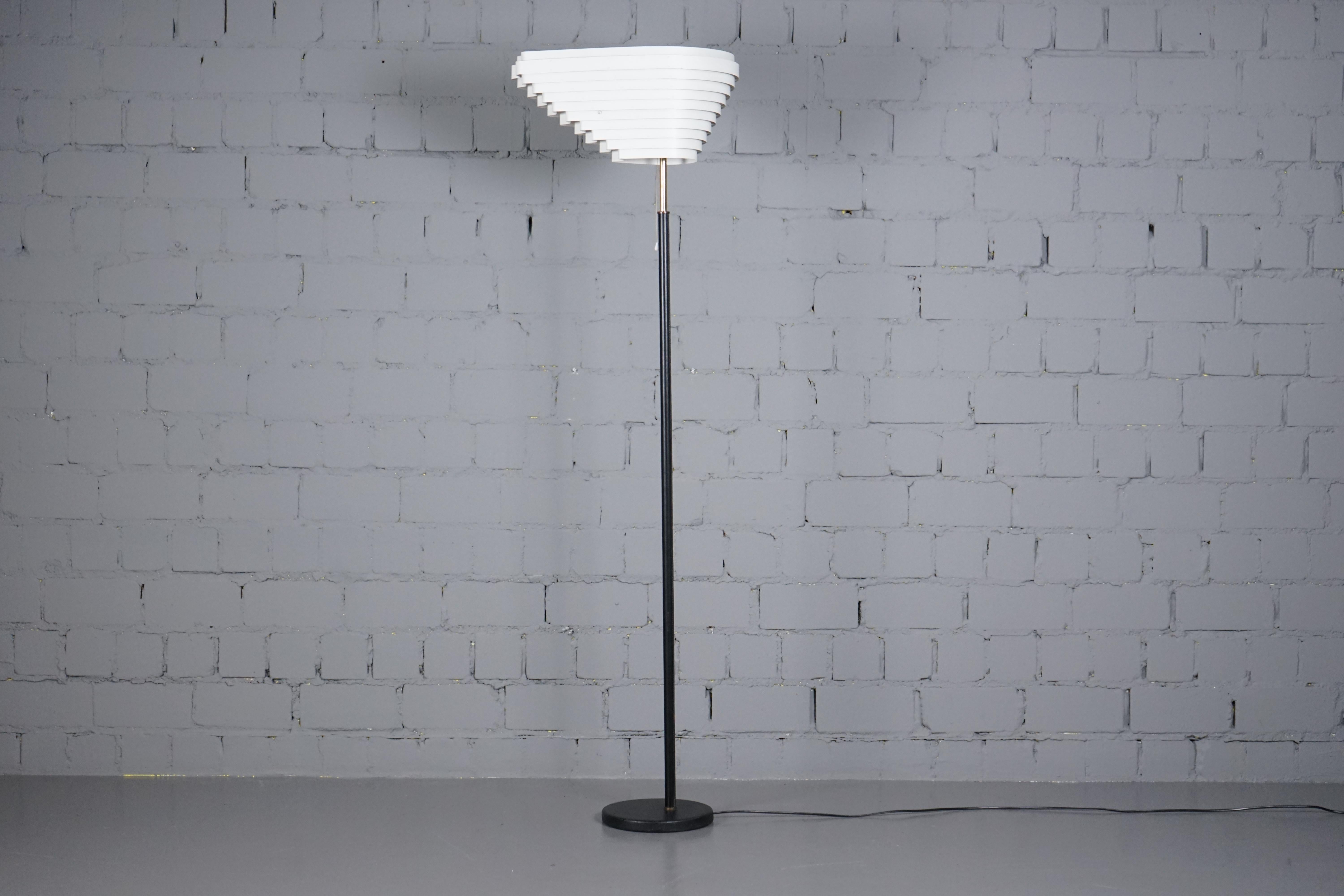 Iconic 1. Edition A805 Angel Wing Floor Lamp by Alvar Aalto for Valaistustyö from the 1950`s. 
The lamp is in original condition with and shows wear consistent with age and use. The shade has its original paint.