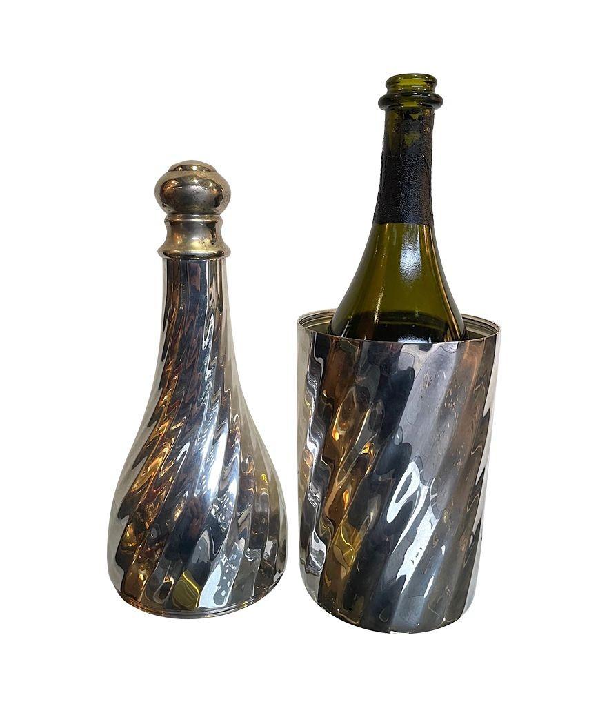 A large 1950s silver plated Champagne bottle cooler in the shape of a champagne bottle, which unscrews in the middle so the bottle can be placed in side. The top can also be unscrewed to poor the champagne without taking it from the cooler. Lovely