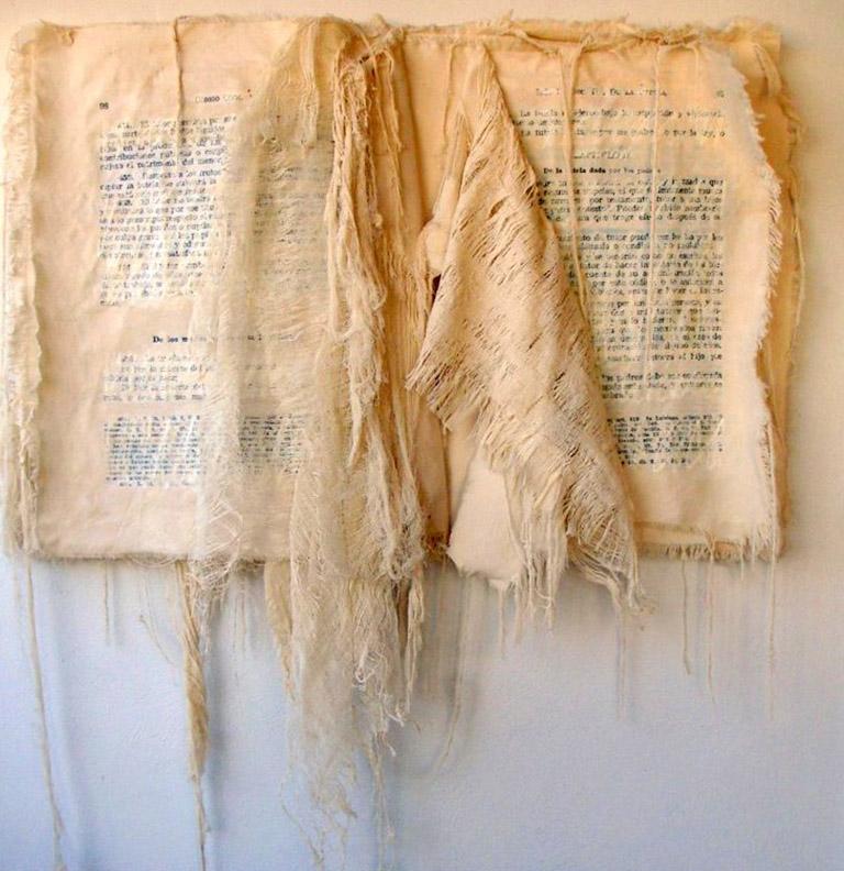 Book Art is an abstract work where the artist combines fabrics, paper, letters to magically create this unique artwork.  This artwork is intentionally distressed.