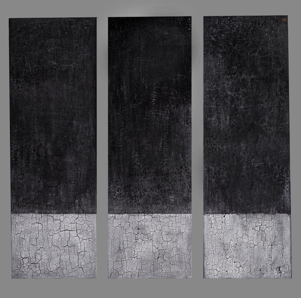Contemporary & abstract in style, this textured triptych is made up of (3) 60" x 20" gallery wrapped canvases. This one a kind abstract painting features a charcoal hue on top, balanced beautifully with a soft, crackled gray on the bottom. Complete