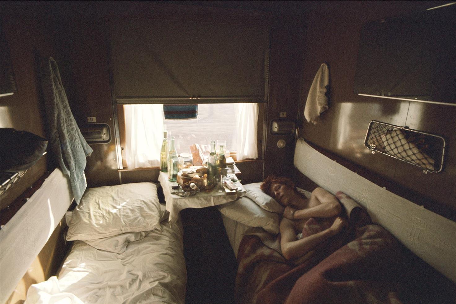 Geoff MacCormack Color Photograph - David Bowie, sleeping on train, 1973