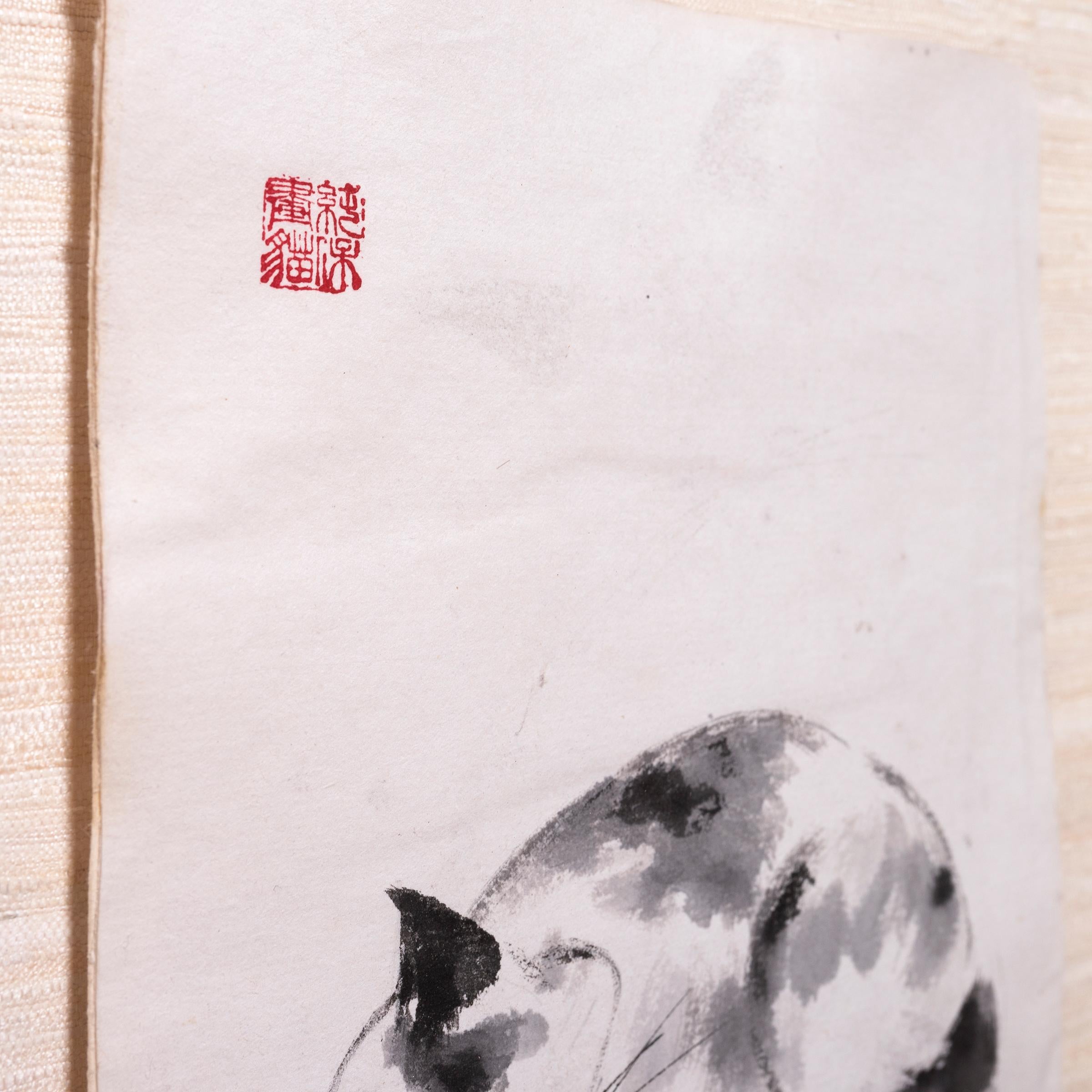 This charming ink painting is a contemporary example of the traditional art of calligraphy painting. With a careful hand, the artist uses just a few brush strokes to capture the innocent nature of a kitten, peacefully sleeping with his head on his