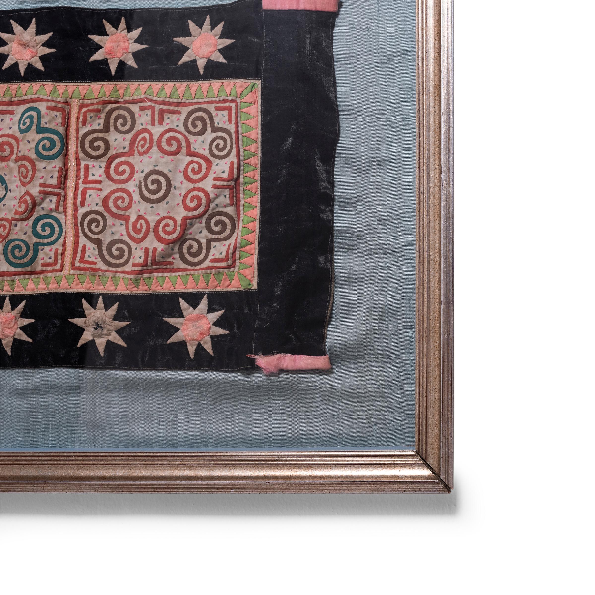 Dating to the mid-20th century, this colorful Hmong textile is a classic example of the appliqué technique used for the traditional cloth known as paj ntaub. Appliqué is the process by which patches of fabric are sewn onto a different piece of