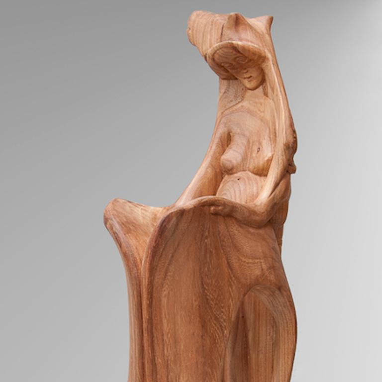 A very personal piece from this artist.  Human figures are carved in this horse sculpture, one of which is in the back of the horse neck and opens its back as a book.

The sculpture is in polished elm wood.

A graduate from the Academy of Fine Arts