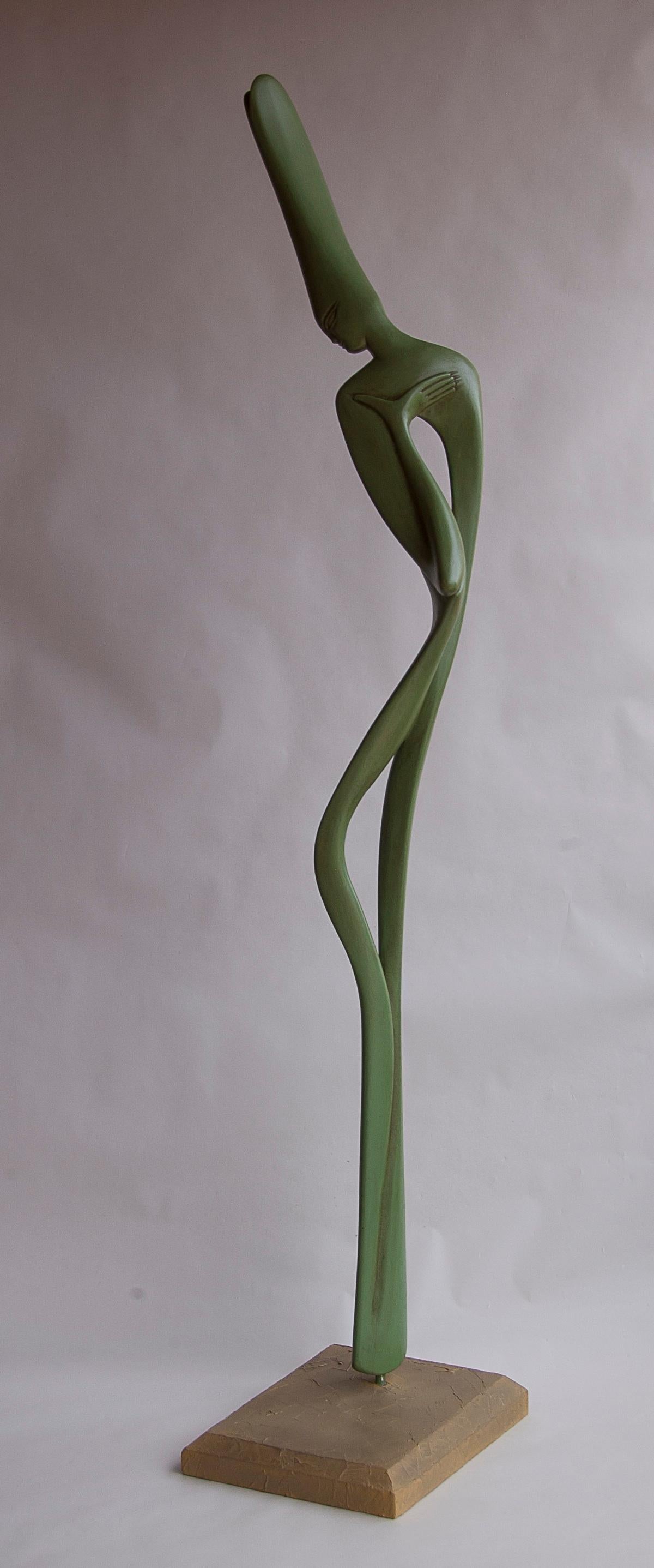 This feminine semi-abstract figurative sculpture depicts a slender woman in curves and softness, with an inner space.

The sculpture has an olive green patinated finish.

A graduate from the Academy of Fine Arts of Carrare, in Italy, Lutfi Romhein
