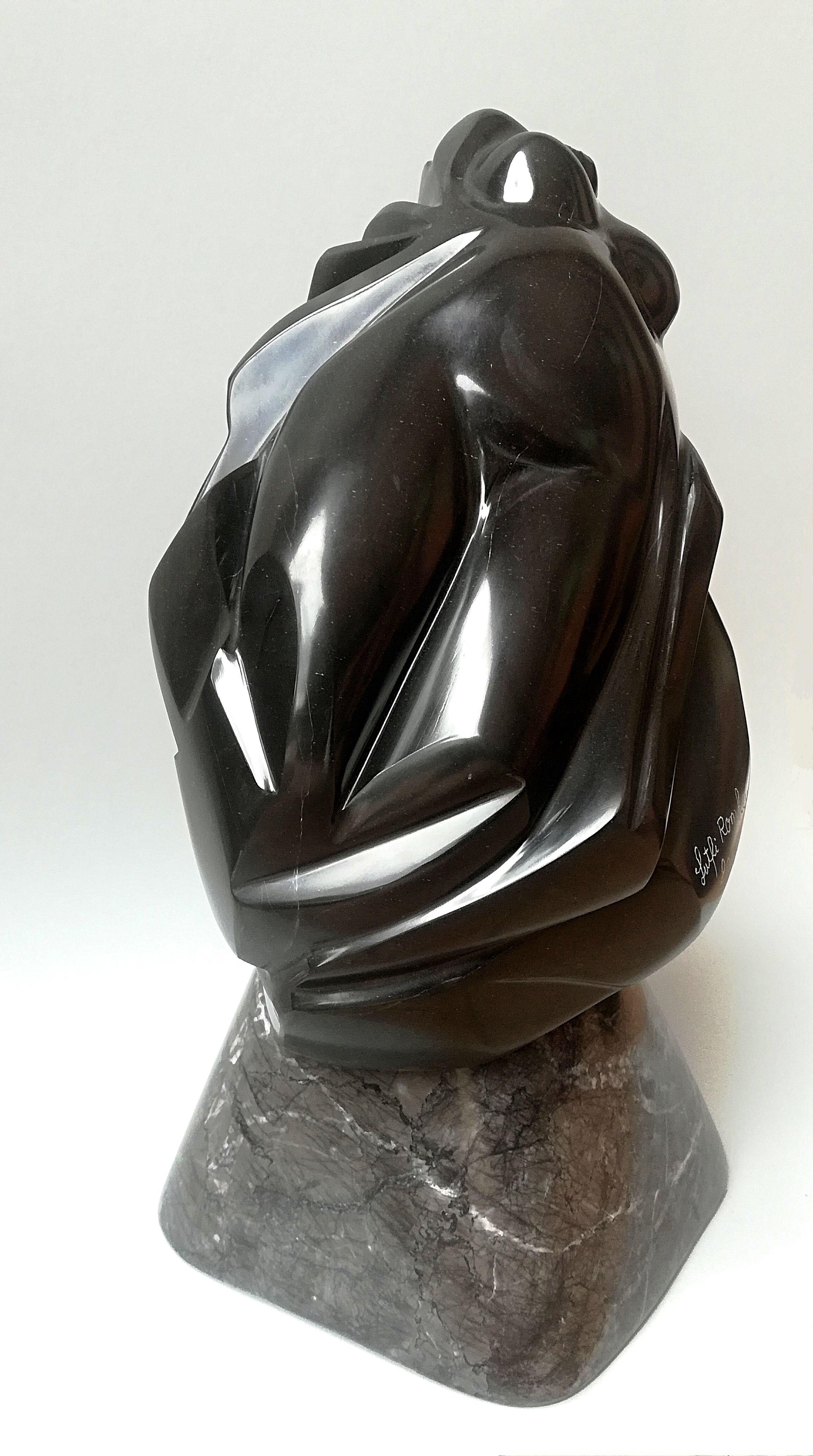 This figurative sculpture by Lutfi Romhein depicts a female nude bust in Belgian black marble mounted on a grey marble base. It has a very fine grain which provides a really soft touch. The mirror polished Belgian black marble is simply splendid