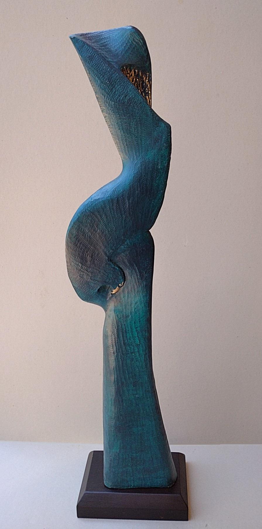 Peaceful face woman with bird, figurative oak wood sculpture covered with a blue and golden patina, by Lutfi Romhein.

A graduate from the Academy of Fine Arts of Carrare, in Italy, Lutfi Romhein is a sculptor of Syrian origin, living in France