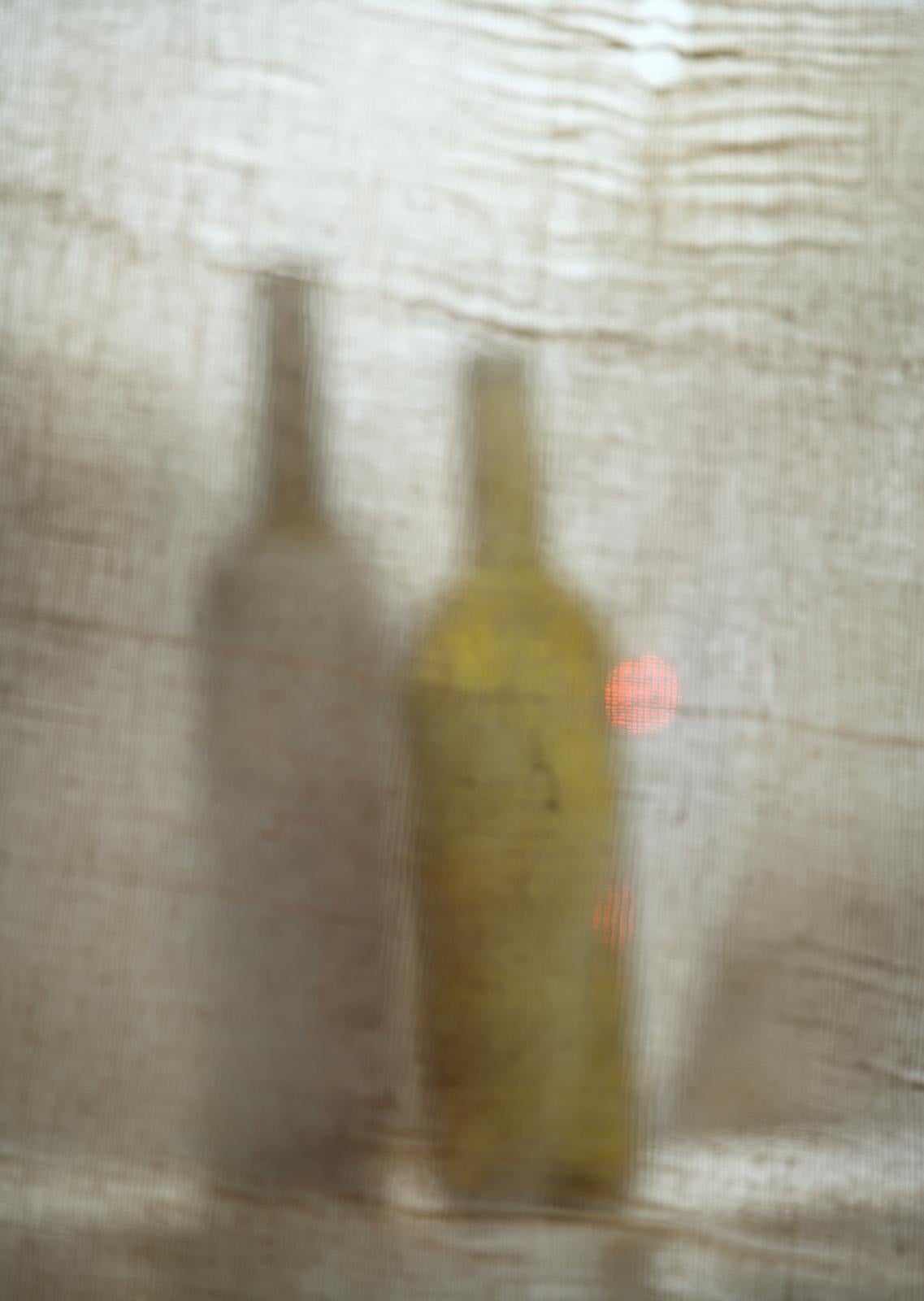 'It Will Rain Tomorrow' by Vitalii Ledokollov -  is a beautiful minimalist abstract figurative photography print. Bottles are used to create a subtle effect of figures. The artist brings life to ordinary subjects and reflects on relationships in the
