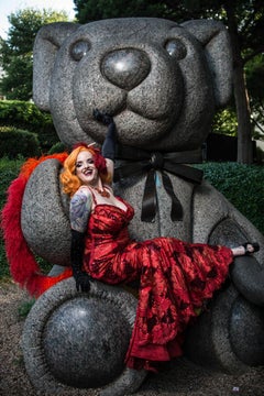 Vivienne by Can Turkyilmaz. Bright red dress posing on a teddy bear sculpture