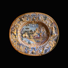 Oval Italian ceramic dish adorned with baroque figures and decoration in relief