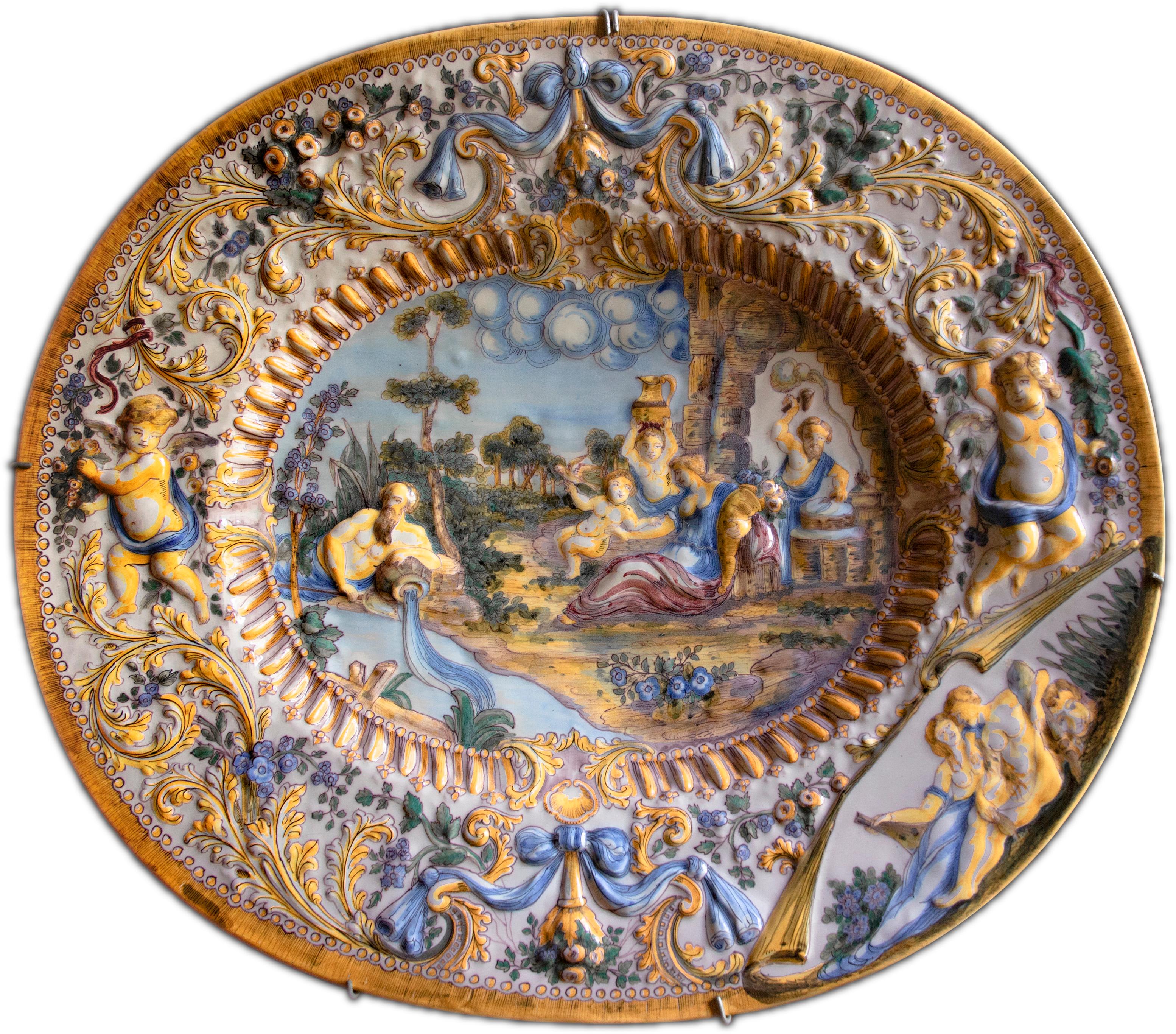 Oval Italian ceramic dish adorned with baroque figures and decoration in relief - Art by Unknown