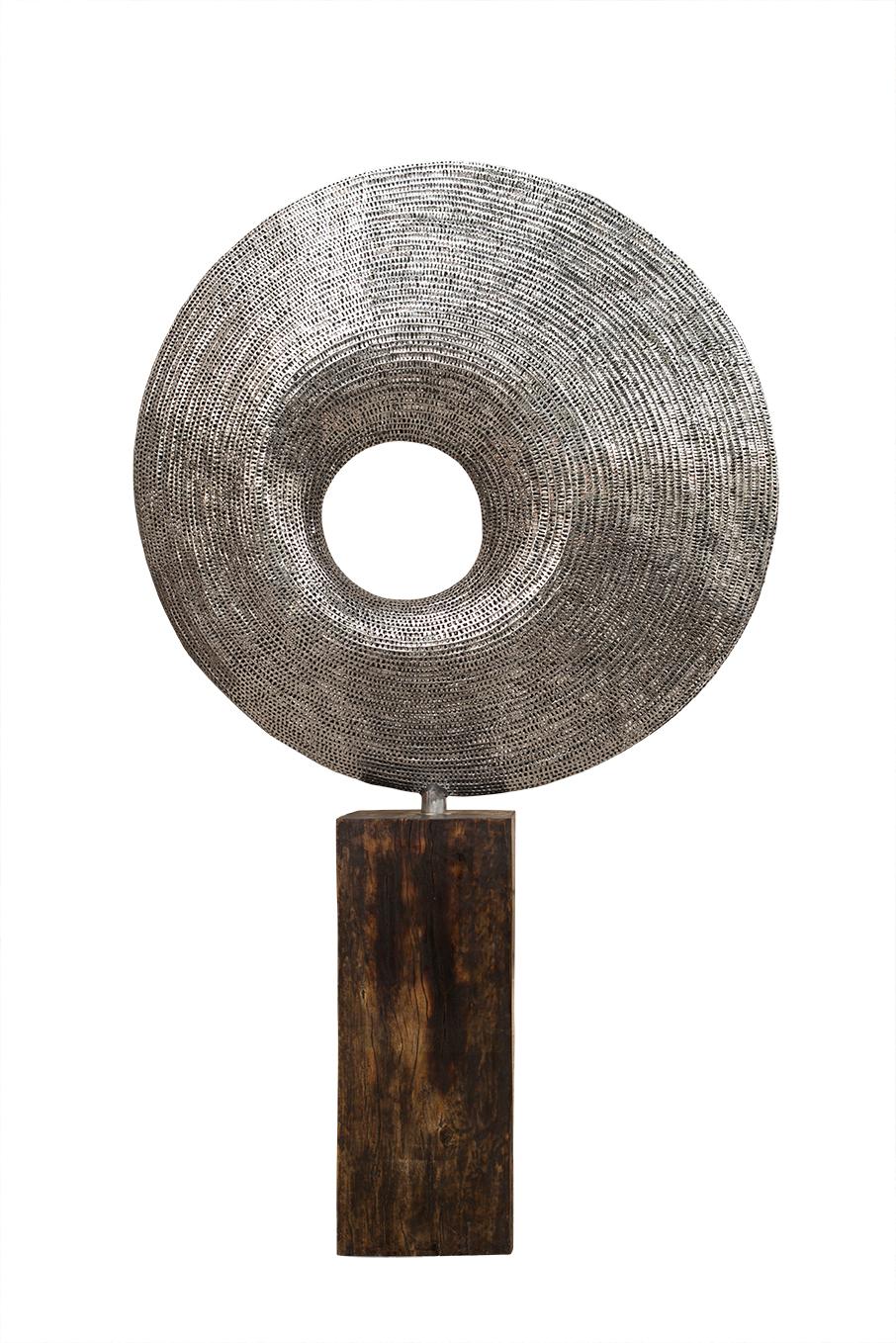Stainless steel sculpture with wooden base.

Liechennay's works are inspired by nature and life, simply put, the forms and shapes he is surrounded by. He creates highly aesthetic pieces embodying artistic balance and beauty that transmit a sense of