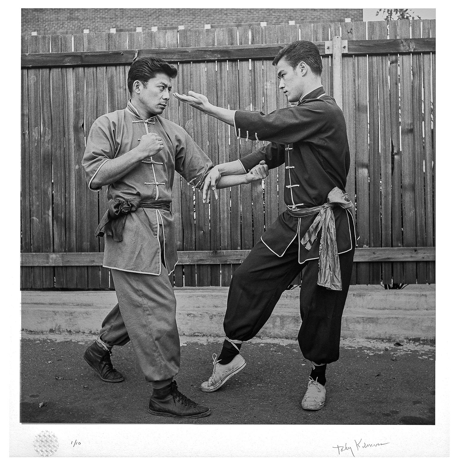 A rare and evocative fine art print of martial arts legend, Bruce Lee, demonstrating  'Hueng Sao with Bil Jee' with his most senior student. (Limited Edition 6 out of 10)

This beautiful, premium quality, black & white print measures 71 x 75cm (28 x