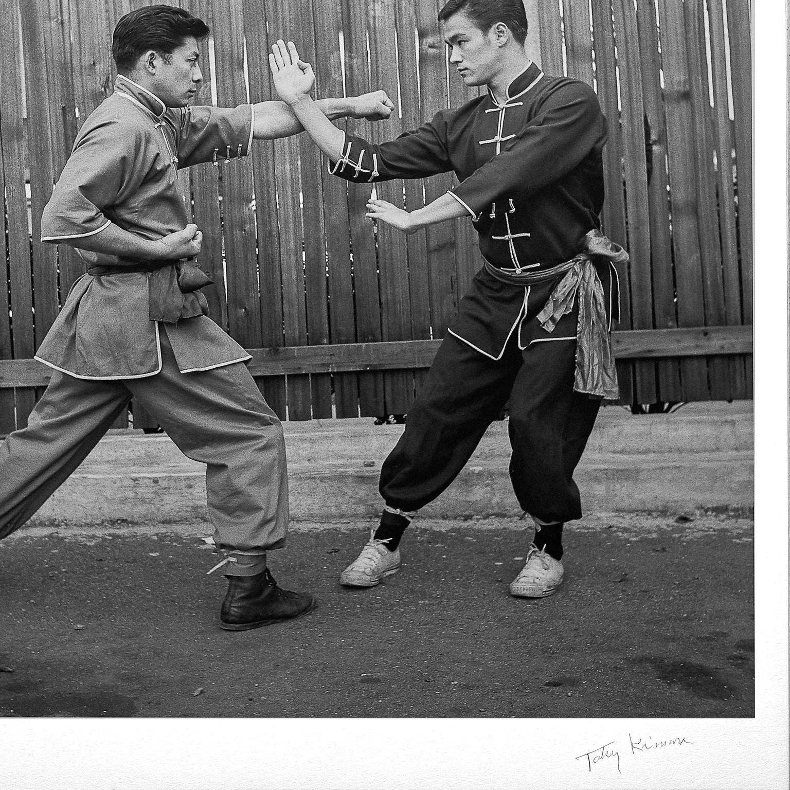 A rare and evocative fine art print of martial arts legend, Bruce Lee, demonstrating  'Leopard Fist'  with his most senior student. (Limited Edition 5 out of 10)

This beautiful, premium quality, black & white print measures 71 x 75cm (28 x 29.5in)