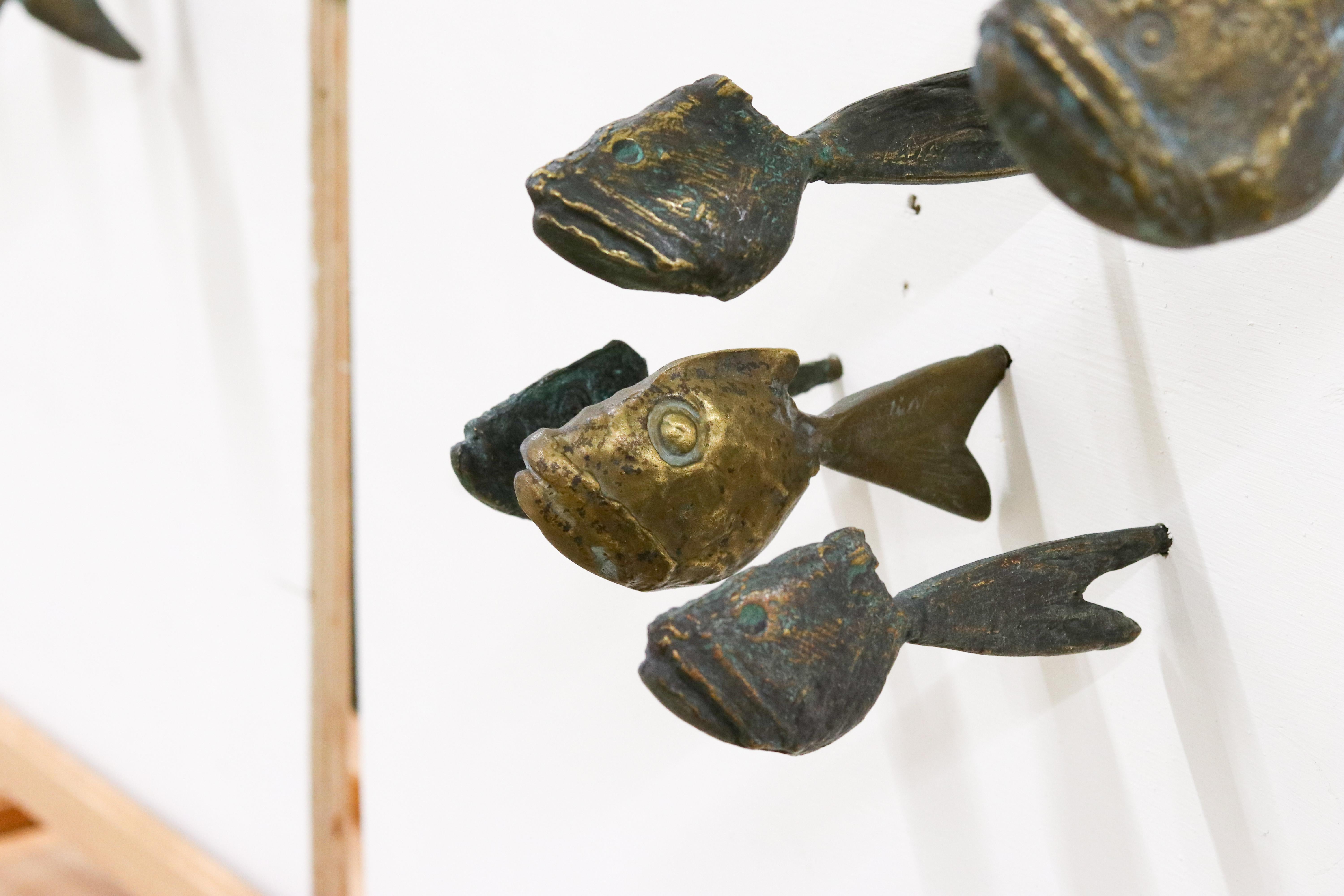 45 fishes of bronze for wall mounting. 
This special bronze object consists of 45 bronze piranhas made by Yrgos Kypris. This Greek artist is known for his fish in all shapes and made of all kinds of material. 

This time he chooses to let the bronze