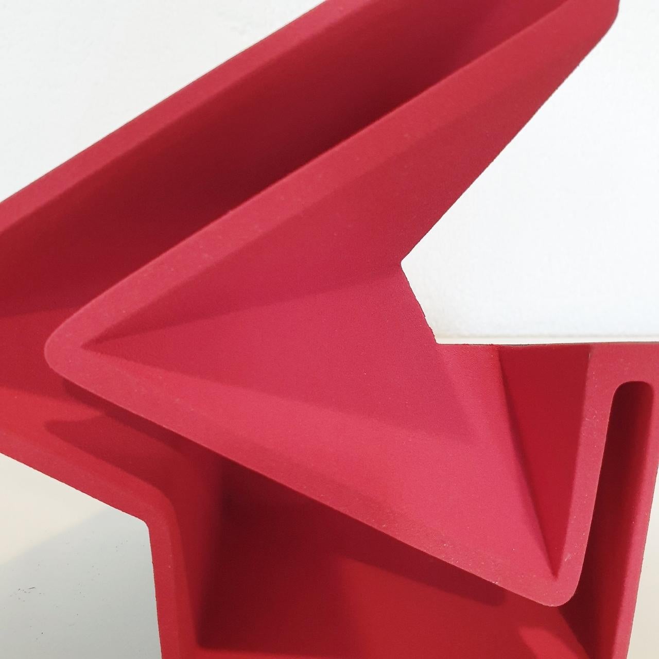 Sculpture SC1503 (red) is a contemporary modern abstract geometric object sculpture by Dutch visual artist Let de Kok. 
This sculpture consists of two ceramic elements and both the red and the black surfaces are textured and rough caused by the