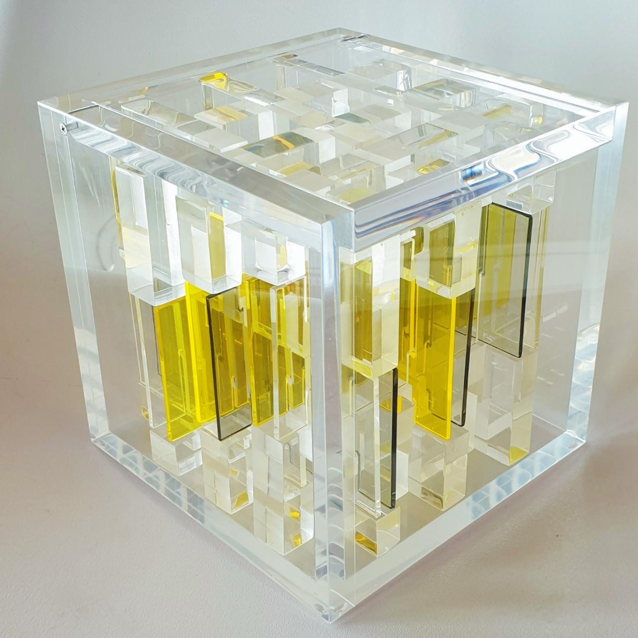Museum Object is a unique small size contemporary modern cube sculpture by the famous Dutch artist couple Nel Haringa and Fred Olijve. The cube sculpture consists of a few dozen hand cut hand polished plexiglass elements carefully stacked together