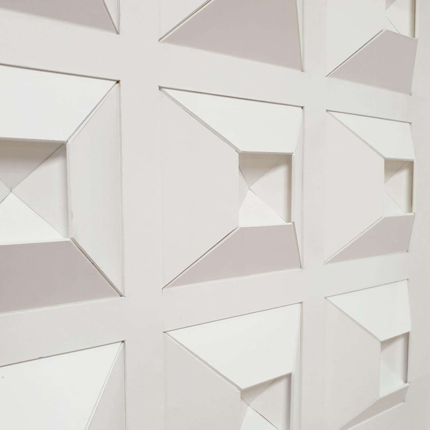 Variation on 9 triangular forms is a unique one-of-a-kind contemporary modern painting relief by Dutch artist Eef de Graaf. The relief is made from meticulously hand-cut plain white cardboard elements that are hand-mounted together forming nine