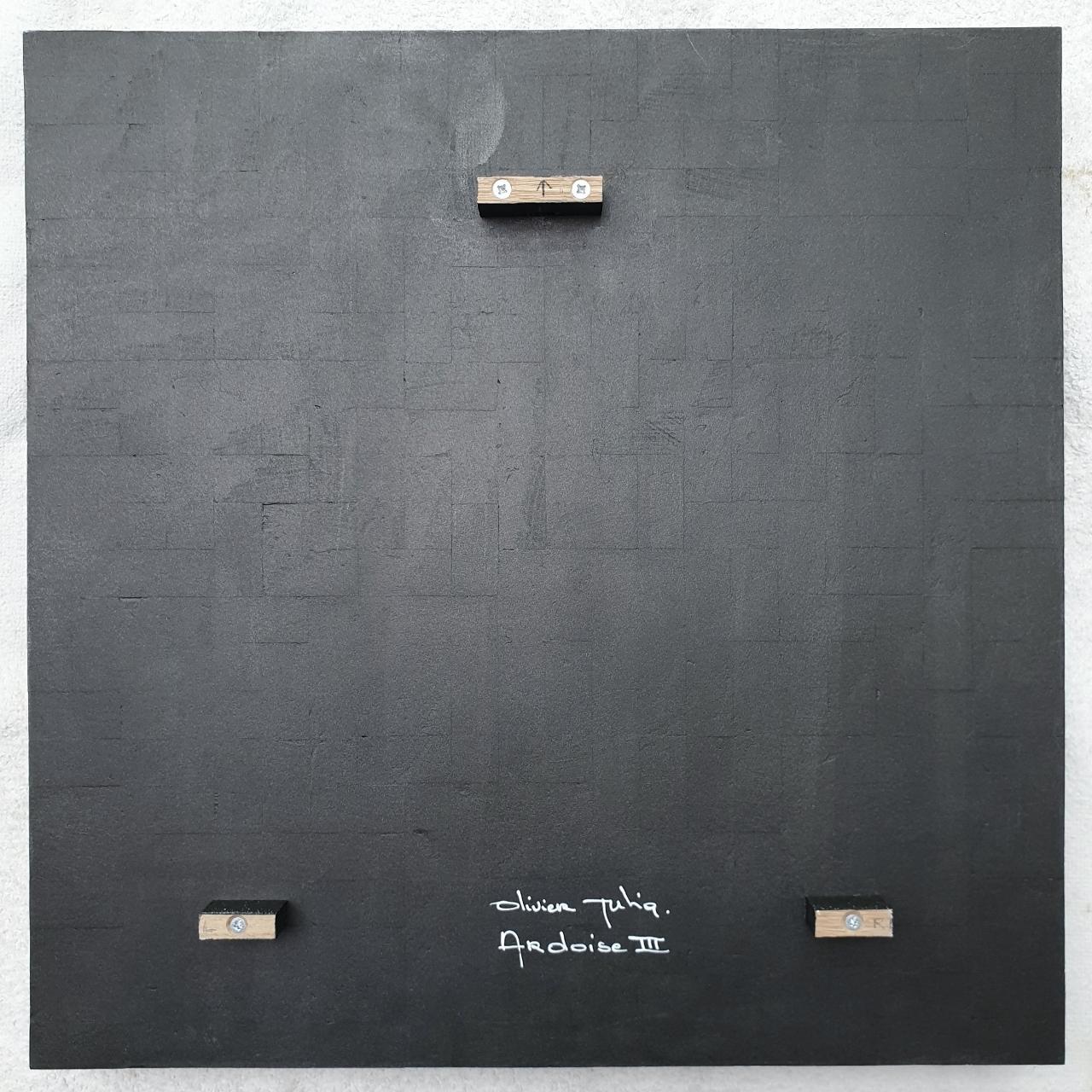 Ardoise III is a medium size contemporary modern sculpture painting relief by French-Dutch artist Olivier Julia. The relief is made from wood and finished with a mixture of anthracite grey and bronze acrylic paint . This art work hangs slightly free
