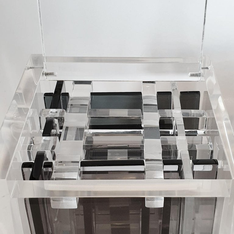 Homage to Bach is a unique small size contemporary modern cube sculpture by the famous Dutch artist couple Nel Haringa and Fred Olijve. The cube sculpture consists of a few dozen hand cut hand polished grey and clear transparent plexiglass elements