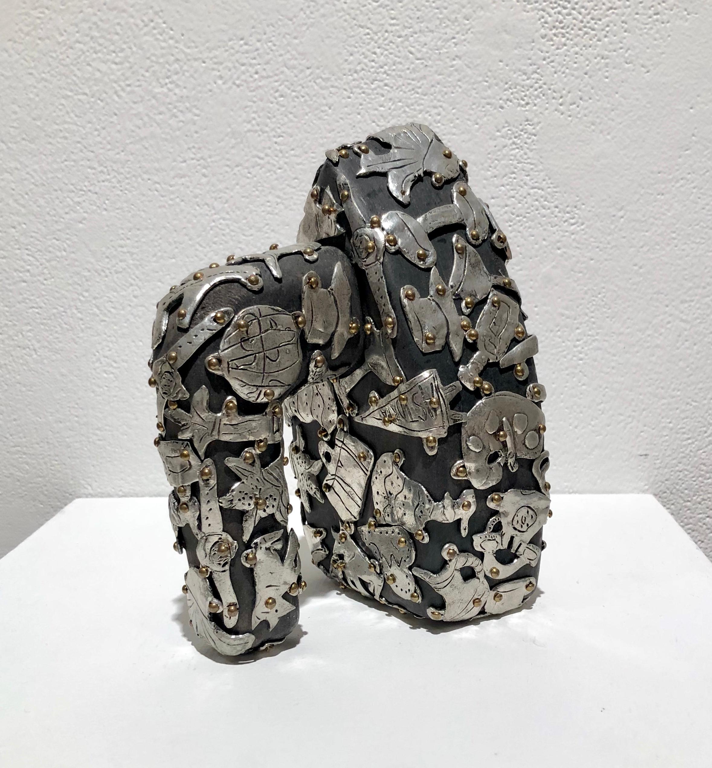 Claudia Demonte, Female Fetish Travel Iron, 2018, pewter and brass on wood, 7 x 5 x 6 in 

Small sculpture of an iron. Pewter objects including balloons, gloves, tennis rackets, purses and pennants in pewter adorn the wood bag.

Claudia DeMonte