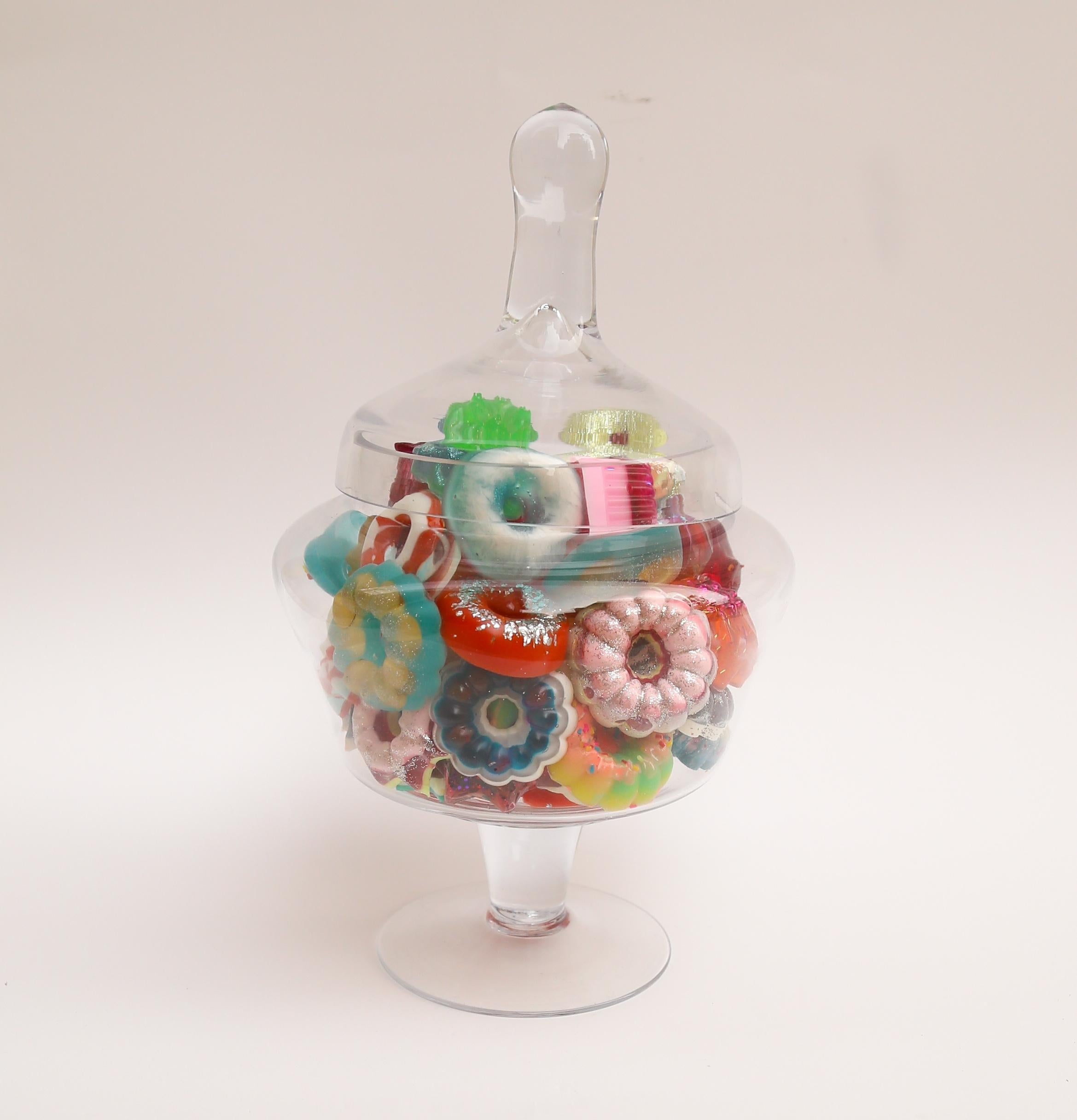 This is a glass candy jar filled with handmade resin donuts by Betsy Enzensberger. The donuts are loose and can be rearranged. The glass container can be emptied and cleaned as needed.

Although the artist is known for her melting popsicle