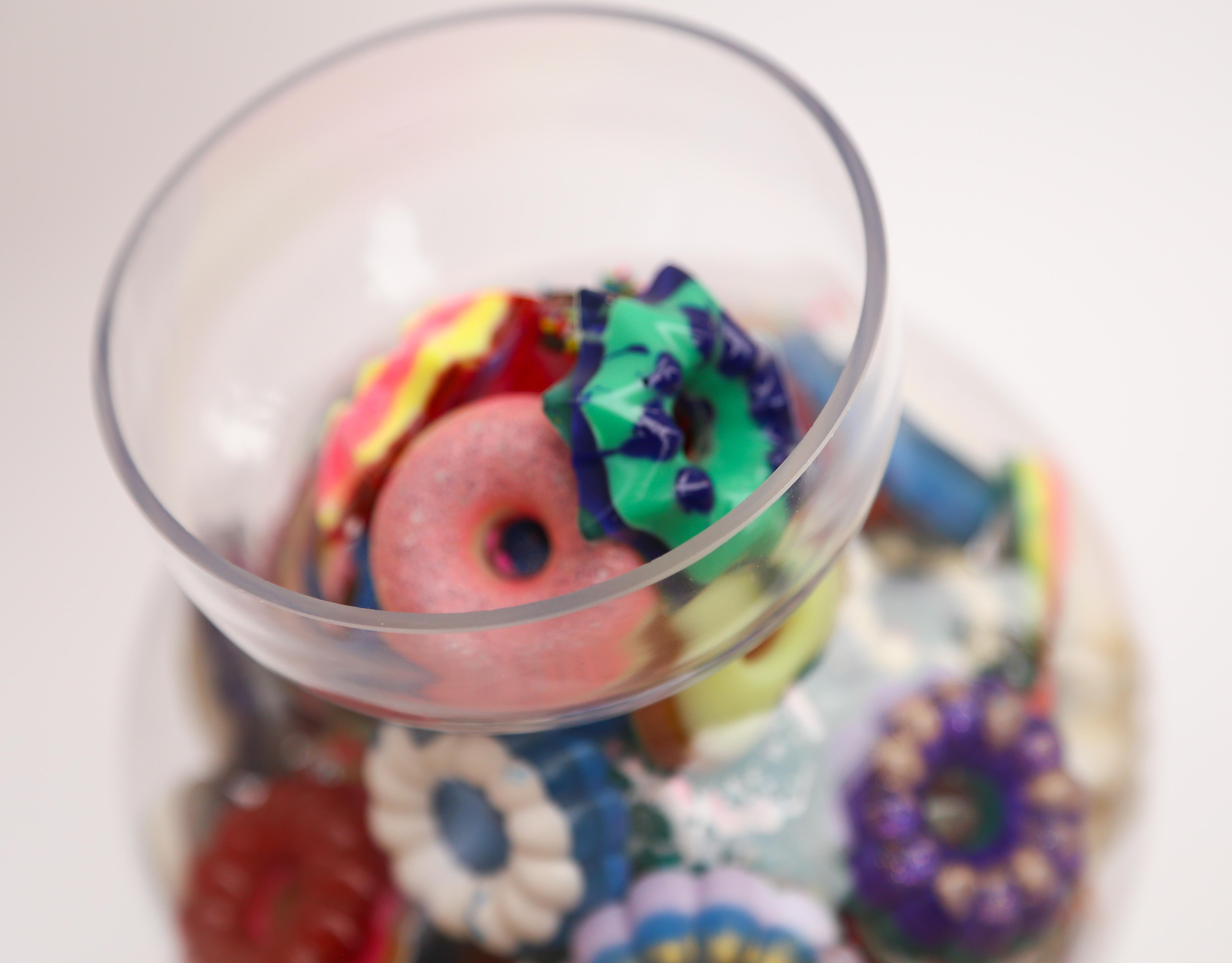 This is a glass candy jar filled with handmade resin donuts by Betsy Enzensberger. The donuts are loose and can be rearranged. The glass container can be emptied and cleaned as needed.

Although the artist is known for her melting popsicle