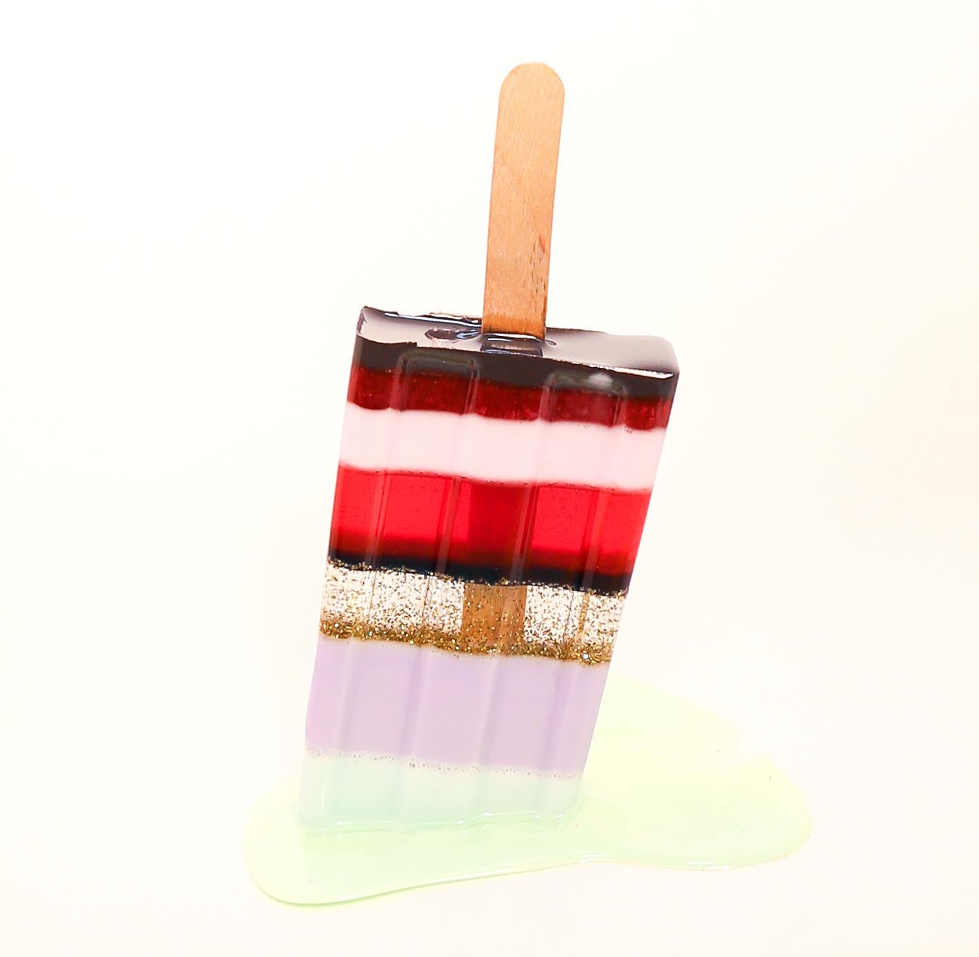 This is a brand new, original resin sculpture by Betsy Enzensberger. It was made with resin, glitter and ink.  This is a life-size sculpture, weighing just a couple of ounces. This popsicle has a large transparent melt which makes an interesting