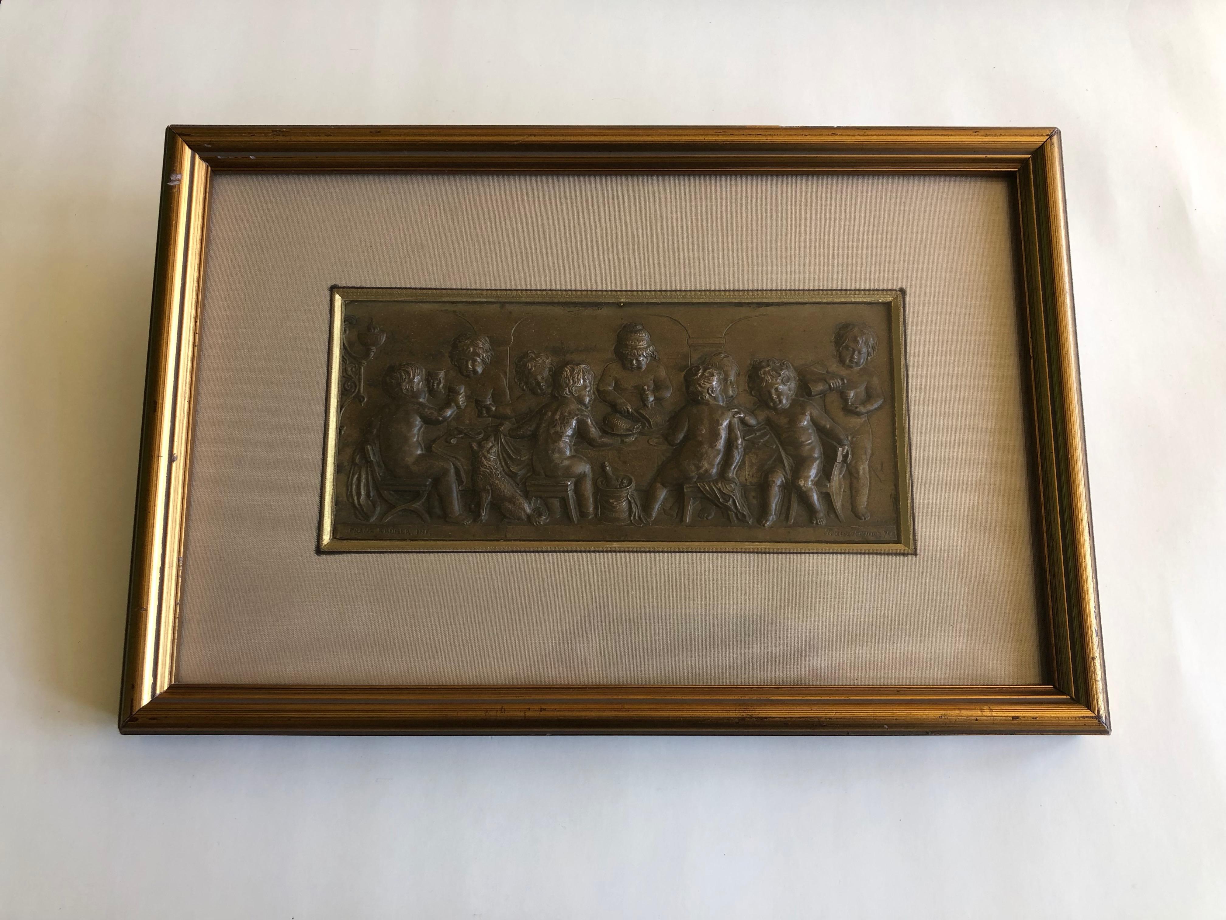 Framed Embossed Bronze Of 9 Cherubs Dining With A Dog, Signed And Dated 1902 - Sculpture by Franz Krüger