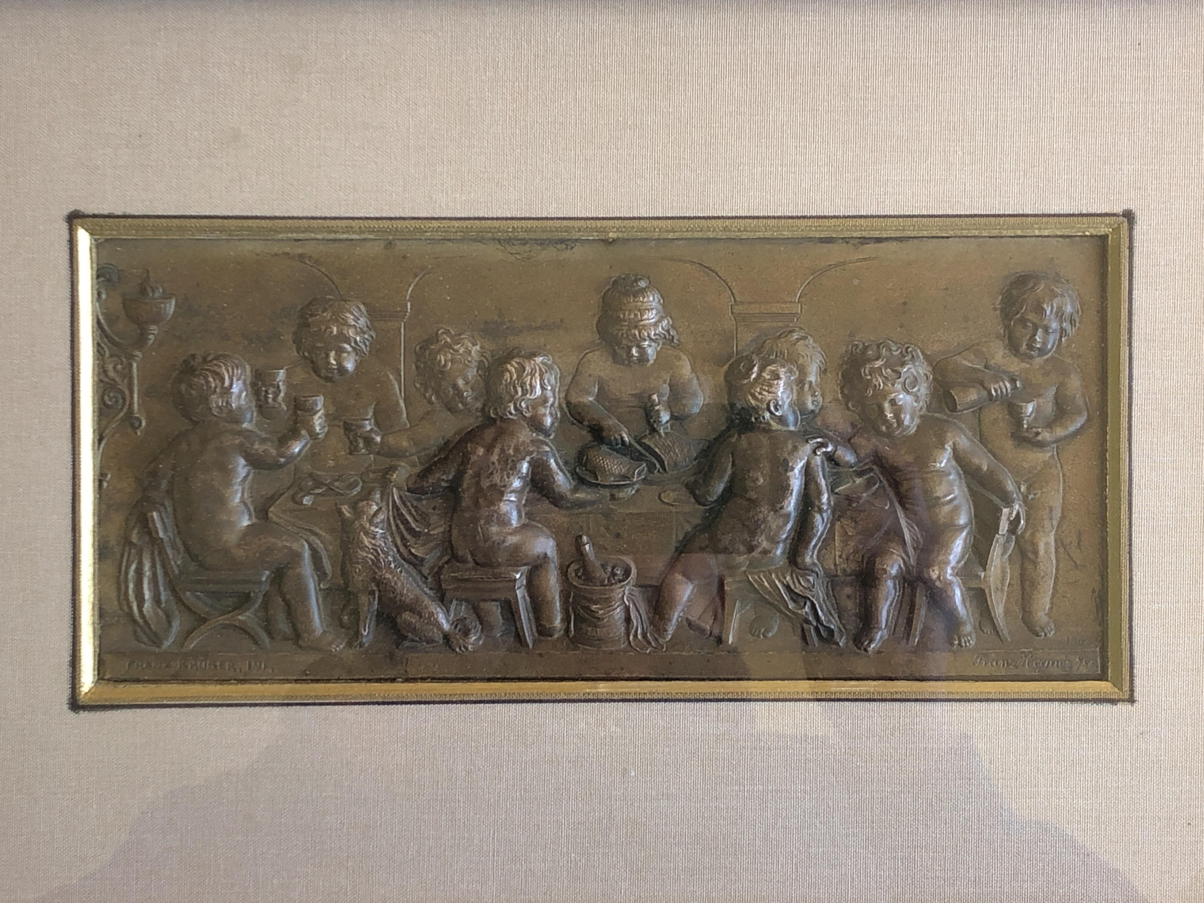 Framed Embossed Bronze Of 9 Cherubs Dining With A Dog, Signed And Dated 1902 - Gold Nude Sculpture by Franz Krüger