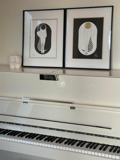 Black and white capsule - line drawing figure with gold disk and stripes