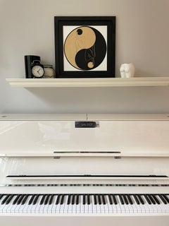 Yin and Yang - line drawing figure in a circle with gold and black disk