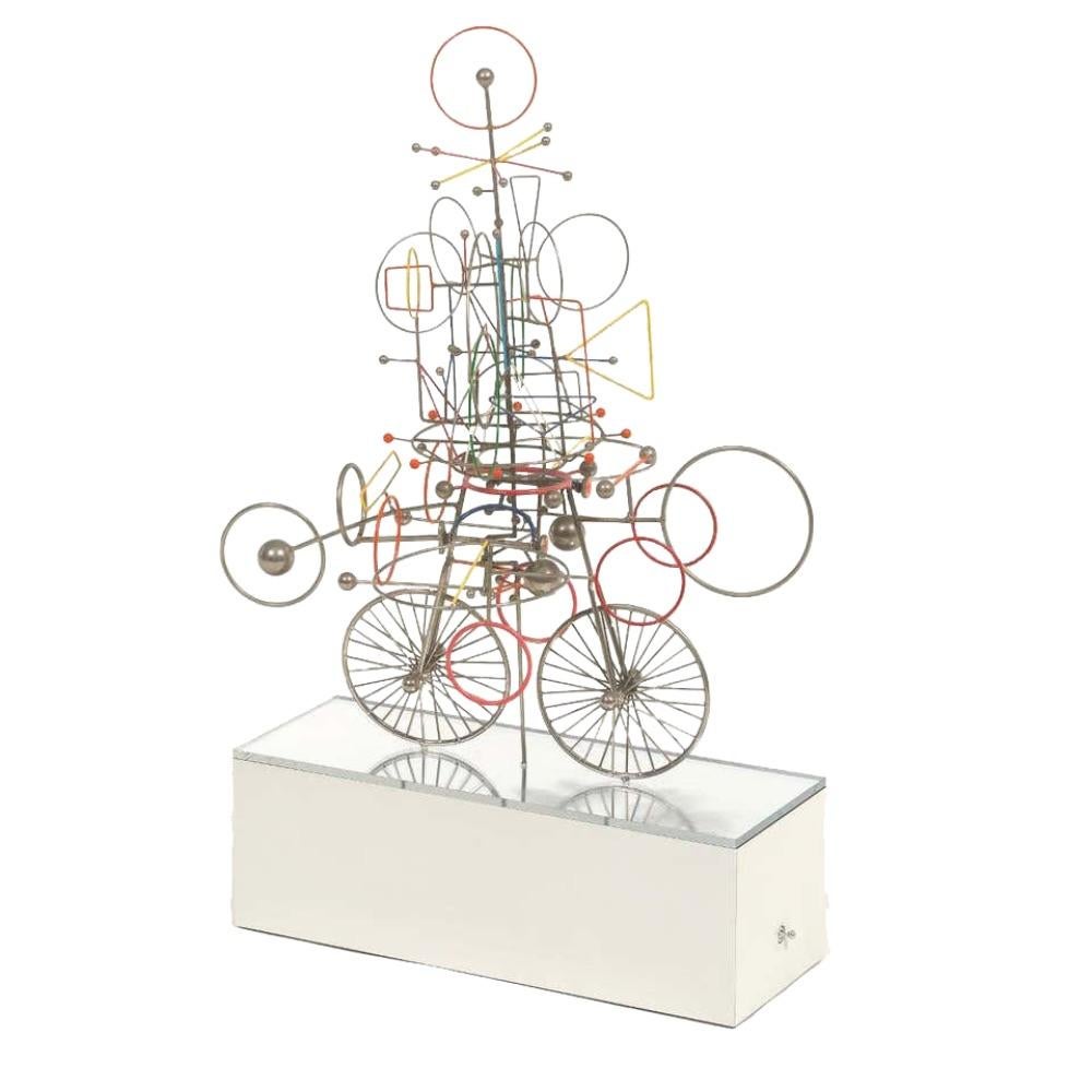 Joseph Burlini (American, b. 1937) Contemporary Kinetic Metal Sculpture, "Flying Machine" 1972

Rainbow painted metal kinetic sculpture mounted to a mirrored base, with switch at the side; battery operated, signed and dated on base. Joseph Burlini