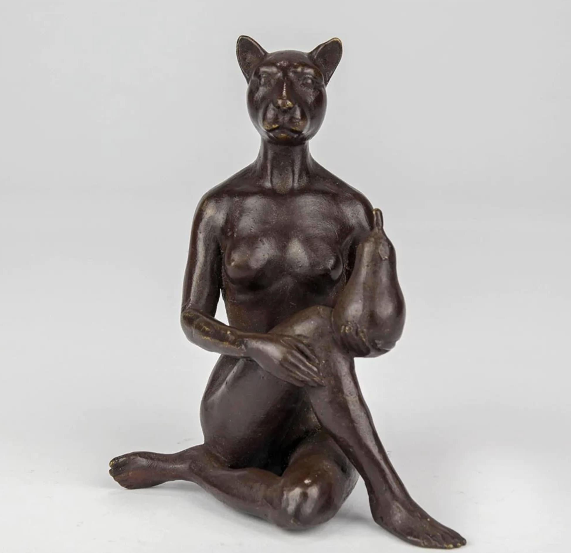 Title: The Pearfect Cat
Authentic bronze sculpture

This authentic bronze sculpture titled 'The Pearfect Cat' by artists Gillie and Marc has been meticulously crafted in bronze. It features Gillie and Marcs catwoman sitting while holding a pear