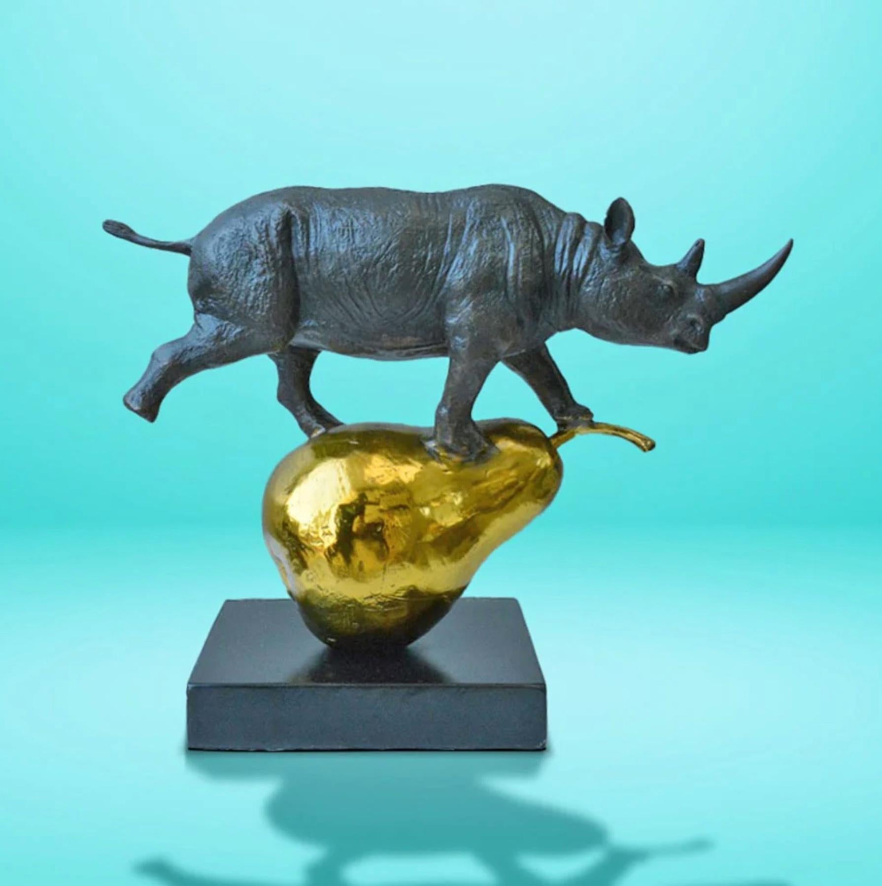 Title: The rhino was just pearfect
Authentic Small Bronze Sculpture

This authentic bronze sculpture titled 'The rhino was just pearfect' by artists Gillie and Marc has been meticulously crafted in bronze with gold patina . This sculpture features a