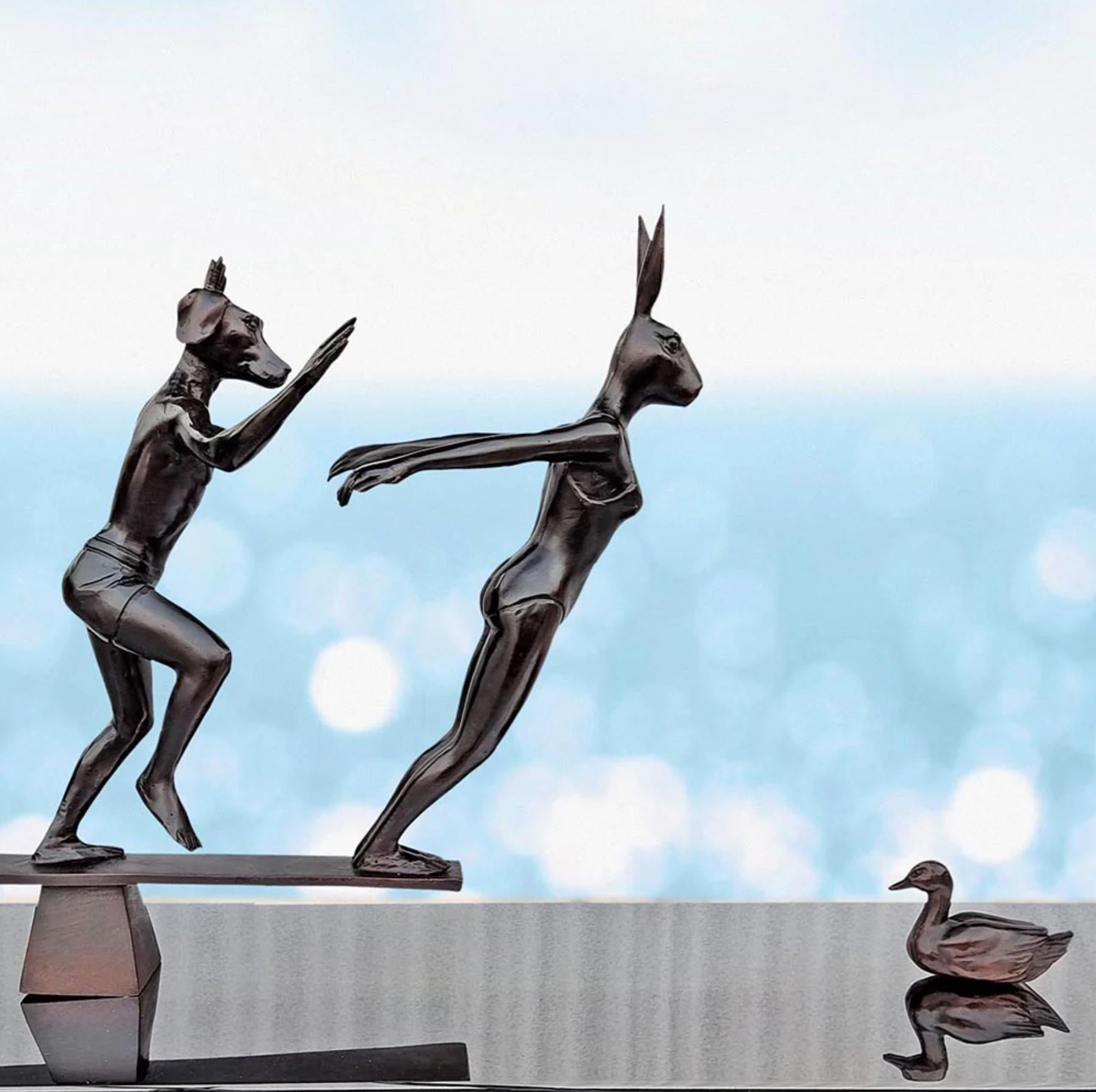 Title: They dived into life
Authentic Small Bronze Sculpture 

This authentic bronze sculpture titled 'They dived into life' by artists Gillie and Marc has been meticulously crafted in bronze. This sculpture features dogman and rabbitwoman diving