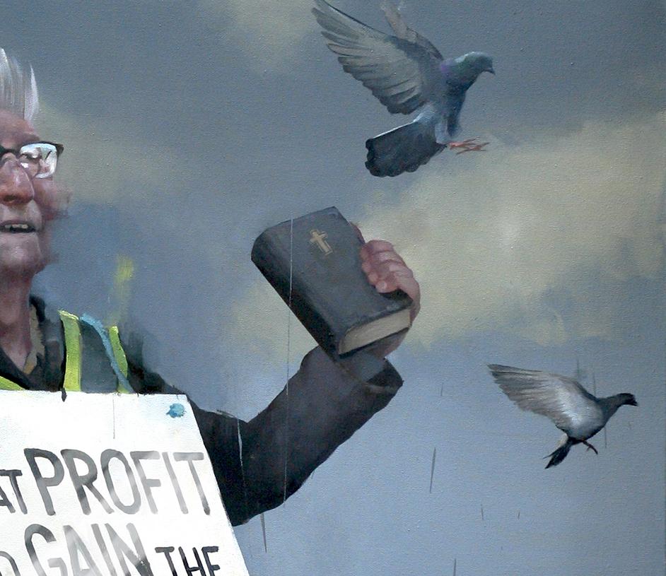 Andrew Hunt's Matthew 12 is a 21st Century oil on canvas painting in figurative realism style depicting a man holding a bible with a sign attached to him, surrounded by pigeons. The painting has religious connotations. Hunt’s blend of painterly