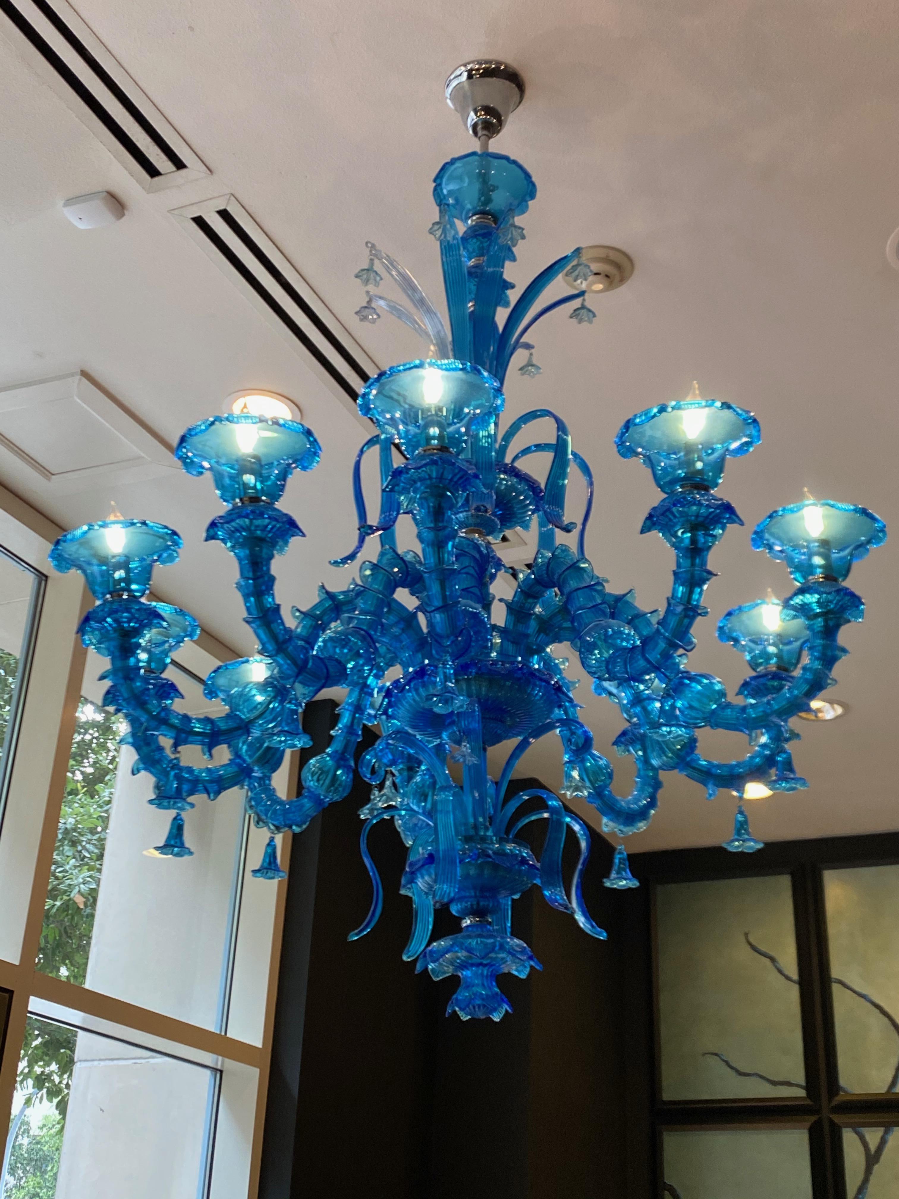 Blue Murano Glass Chandelier

10 lights and 10 arms with hanging flowers and leaves.