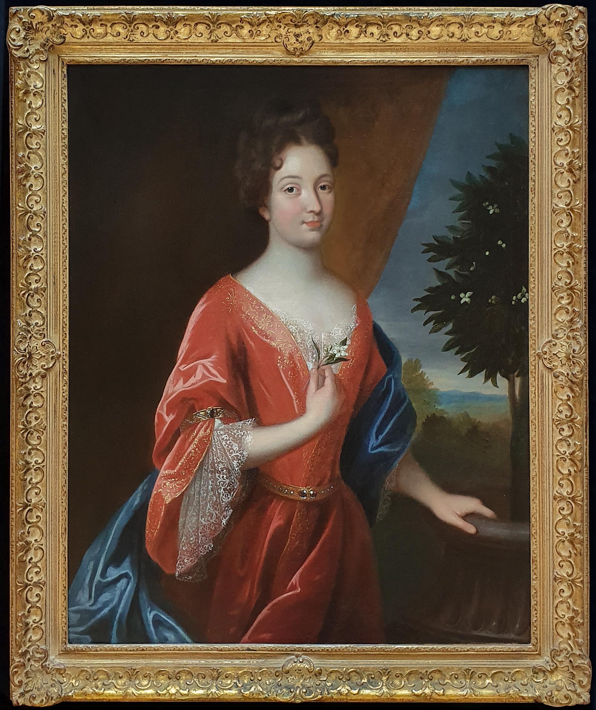 portrait of a lady holding an orange tree flower