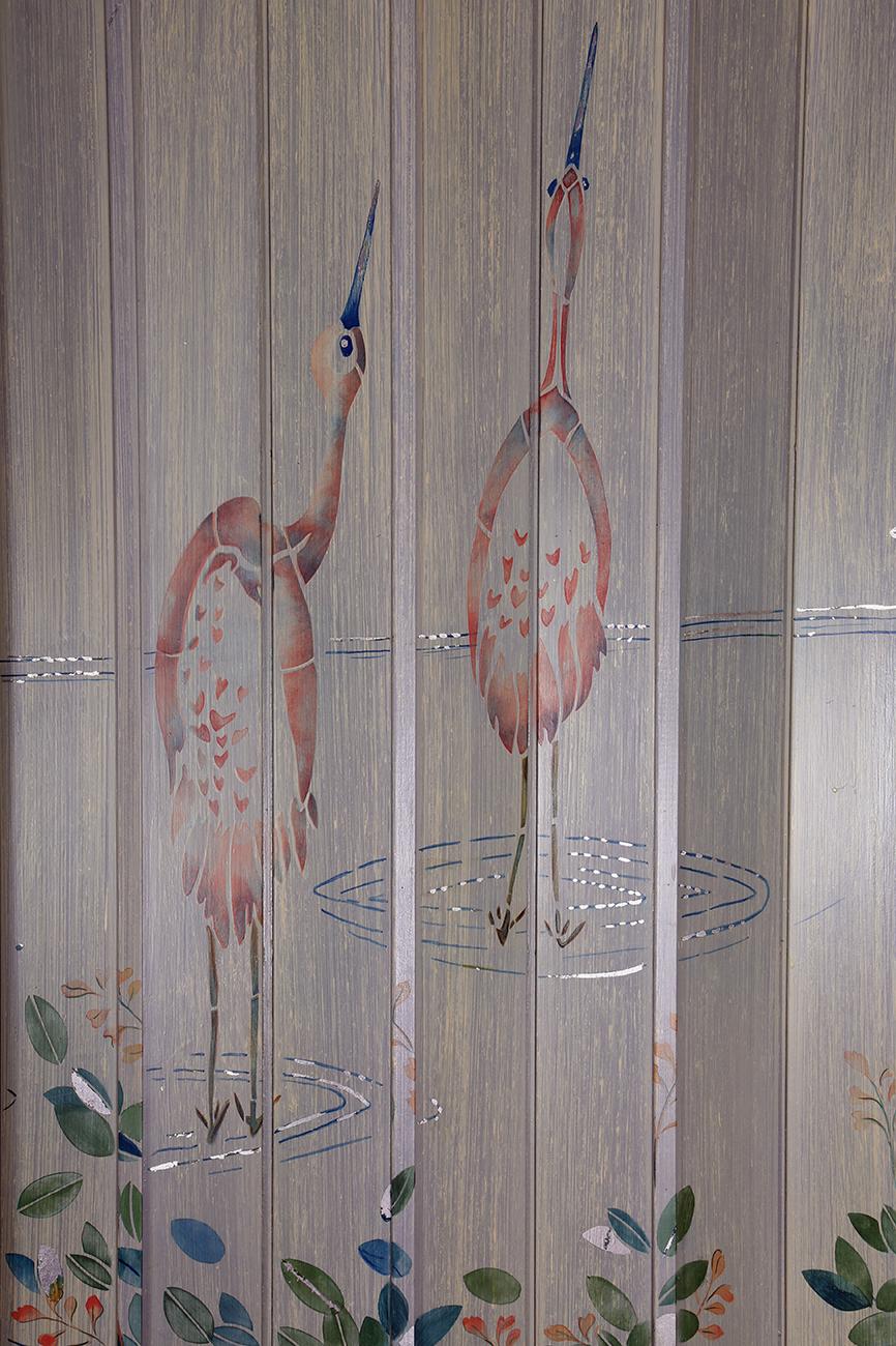 An inspired Orientalist-themed large hand painted decorative fine art folding screen measuring over 6 1/2 feet in length, this is signed and dated 1991 by the Dutch-American female artist Liedeke Bulder. Two separate paintings emerge from the