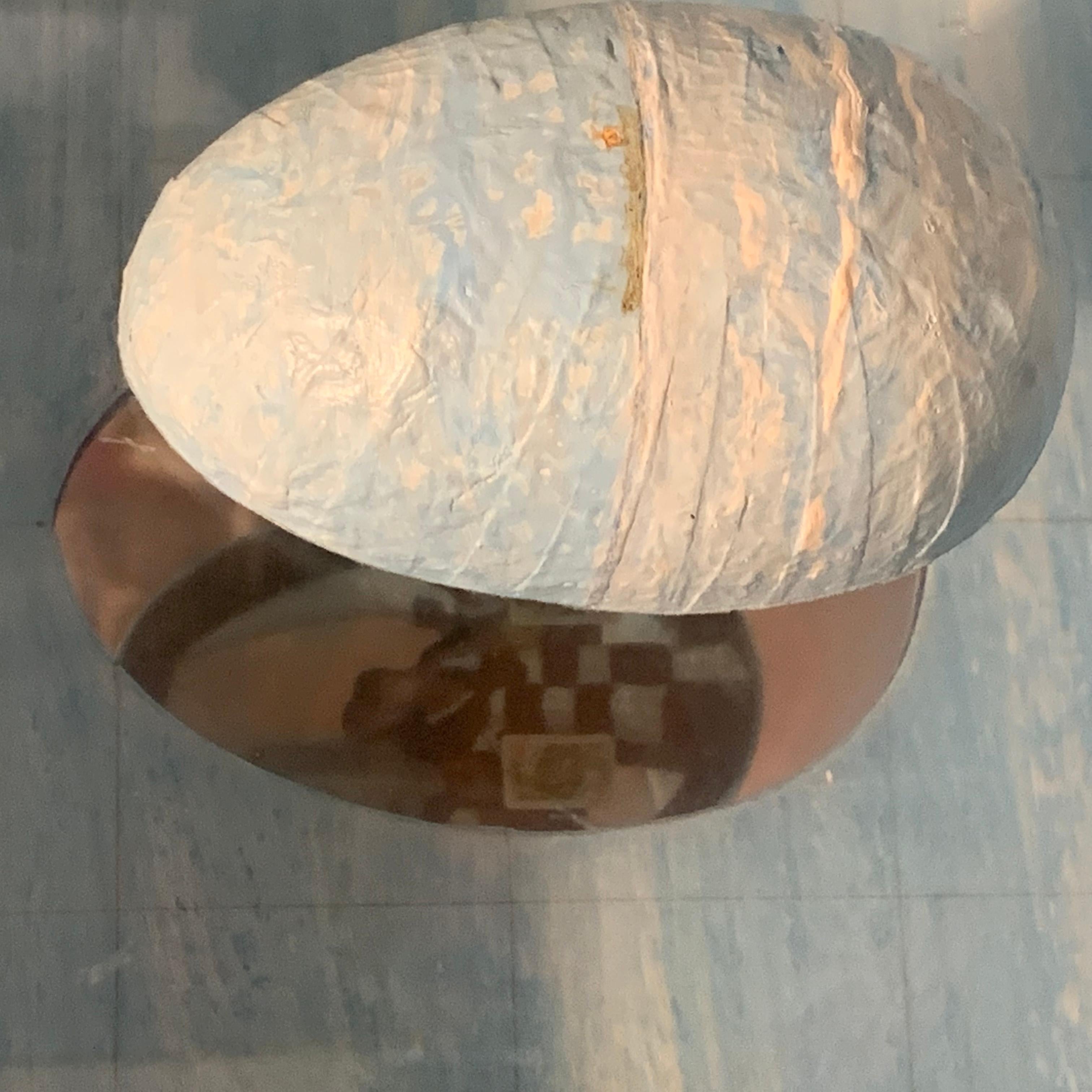 Mixed media assemblage titled Fata Morgana II. Attributed to artist Gordon Wagner. Unsigned. 

The image of a robed plastic figure is contained within the half egg- shaped dome; the figure is wearing a checkered black and white robe and is reflected