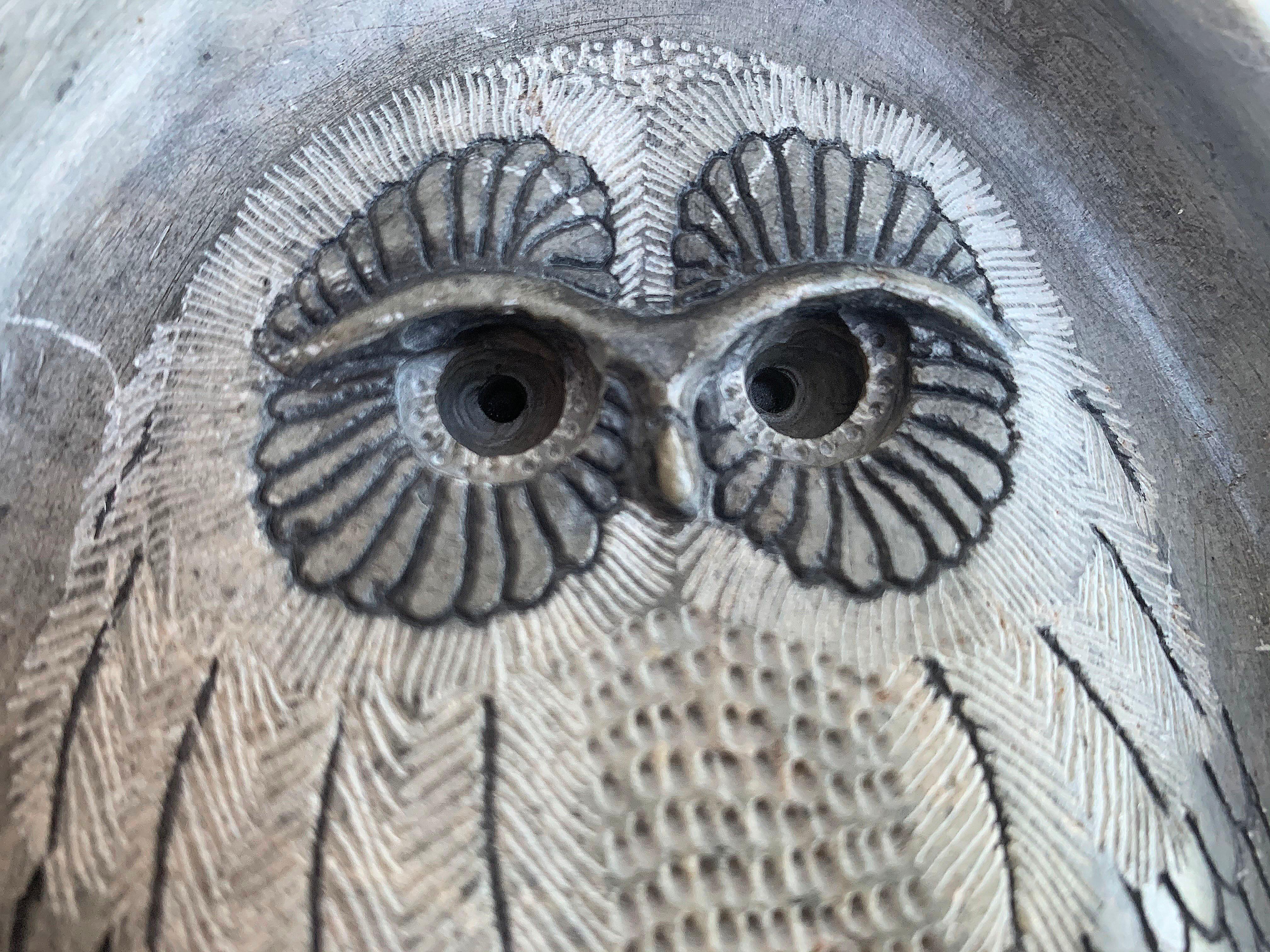 Stone sculpture by Glenn Heath, a well-known California artist. This art piece is carved on one side of a triangle shaped stone, the owl details are both fine in texture and quality. The outer crown is rough in texture and gives the piece added
