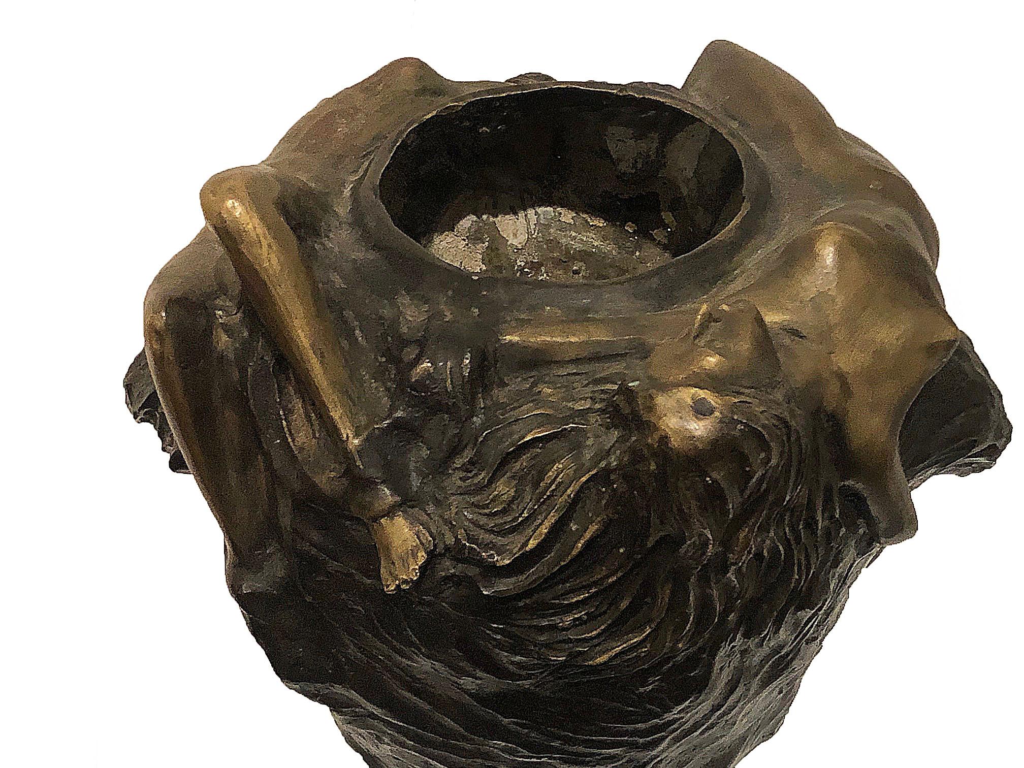 Figurative cast bronze cachepot. This cachepot depicts two nude female figures floating along the top, as though they are immersed in water. Their hair is long and floats on the sides of the planter, giving it much texture.

This piece should be