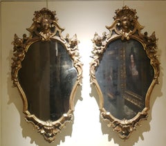 A pair of Tuscan Rococo mirrors gilded carved wood glass