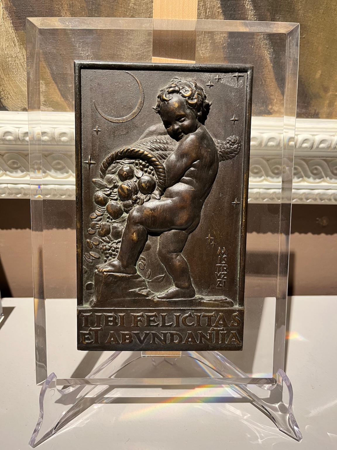 Allegorical bas-relief in bronze and wood with putto and cornucopia - Art by Aurelio Mistruzzi