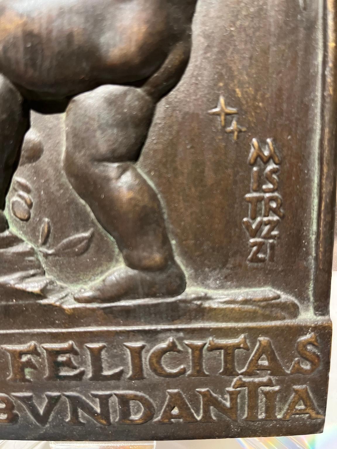 Plaque (bronze 20 x 12 cm, with plexiglass frame 28 x 18 cm) with bas-relief representing a putto with a cornucopia and the crescent moon. At the bottom runs in capital letters a Latin inscription 