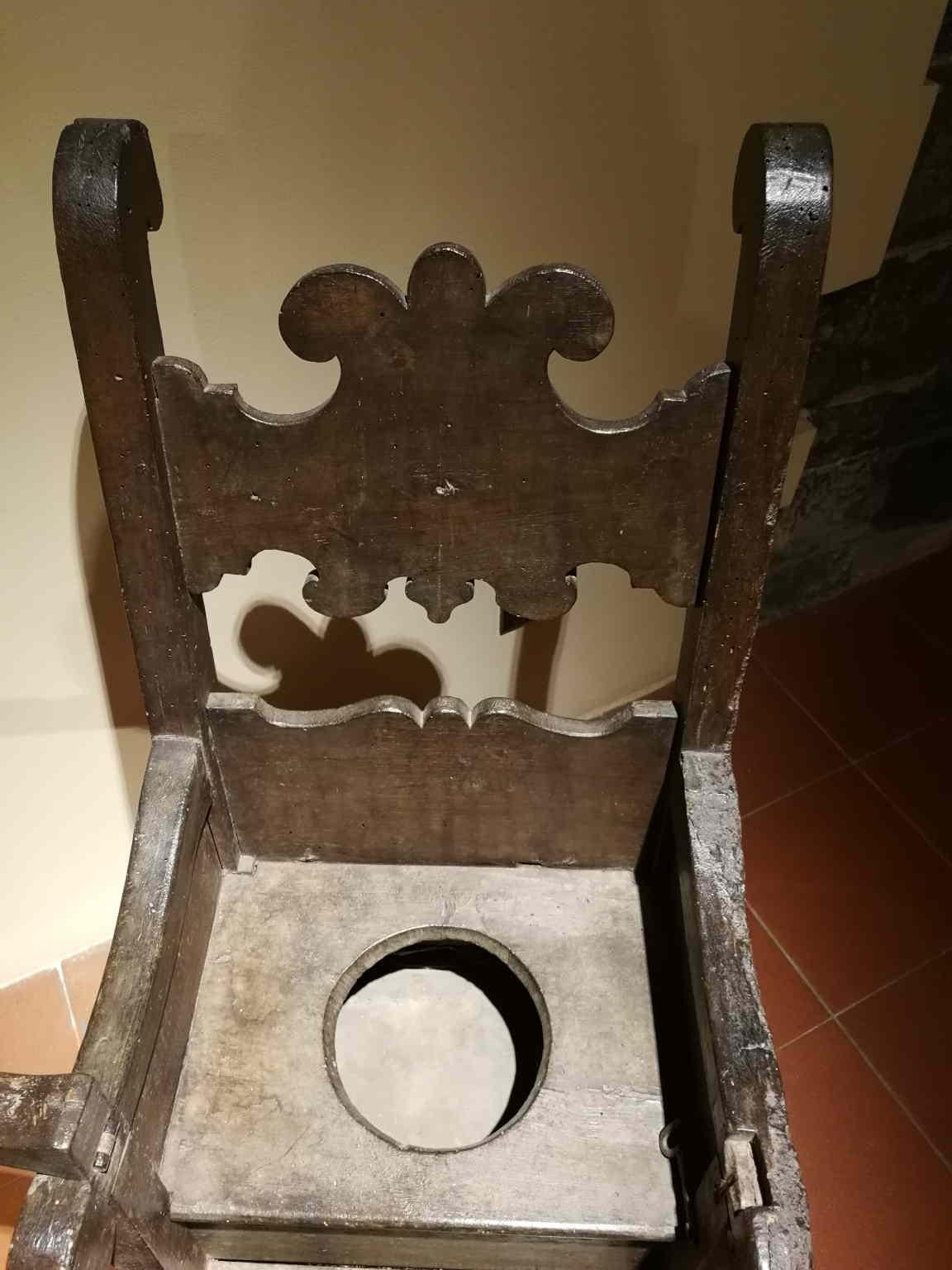 This rare object is a child toilet chair that was very common during the Renaissance time in every aristocratic house. The noble origin is  also highlighted by the decoration with the cartouche in the seatback.

On the back there is a small door